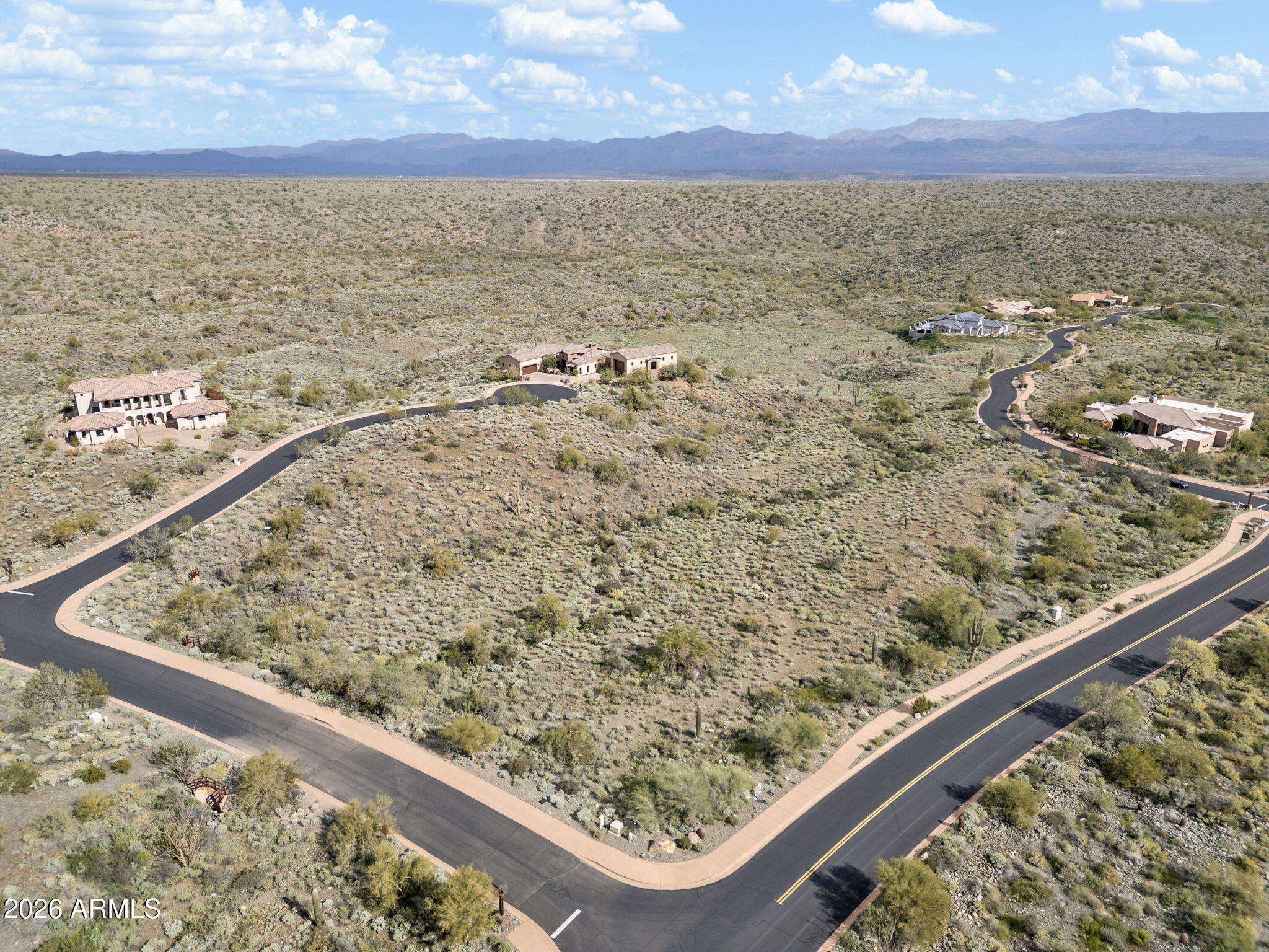 Discover the perfect canvas for your desert masterpiece on this premier 1.04-acre corner lot in the exclusive Eagles Nest enclave. Unlike steep neighboring lots, the terrain here is gentle and lush with mature Saguaros for instant natural landscaping.  Enjoy sweeping views of Four Peaks, the McDowell Mountains, and city lights. The corner location provides a natural buffer for privacy, while the rare flat topography creates an effortless path to realizing your vision—whether a modern architectural marvel or a Santa Barbara-style villa.