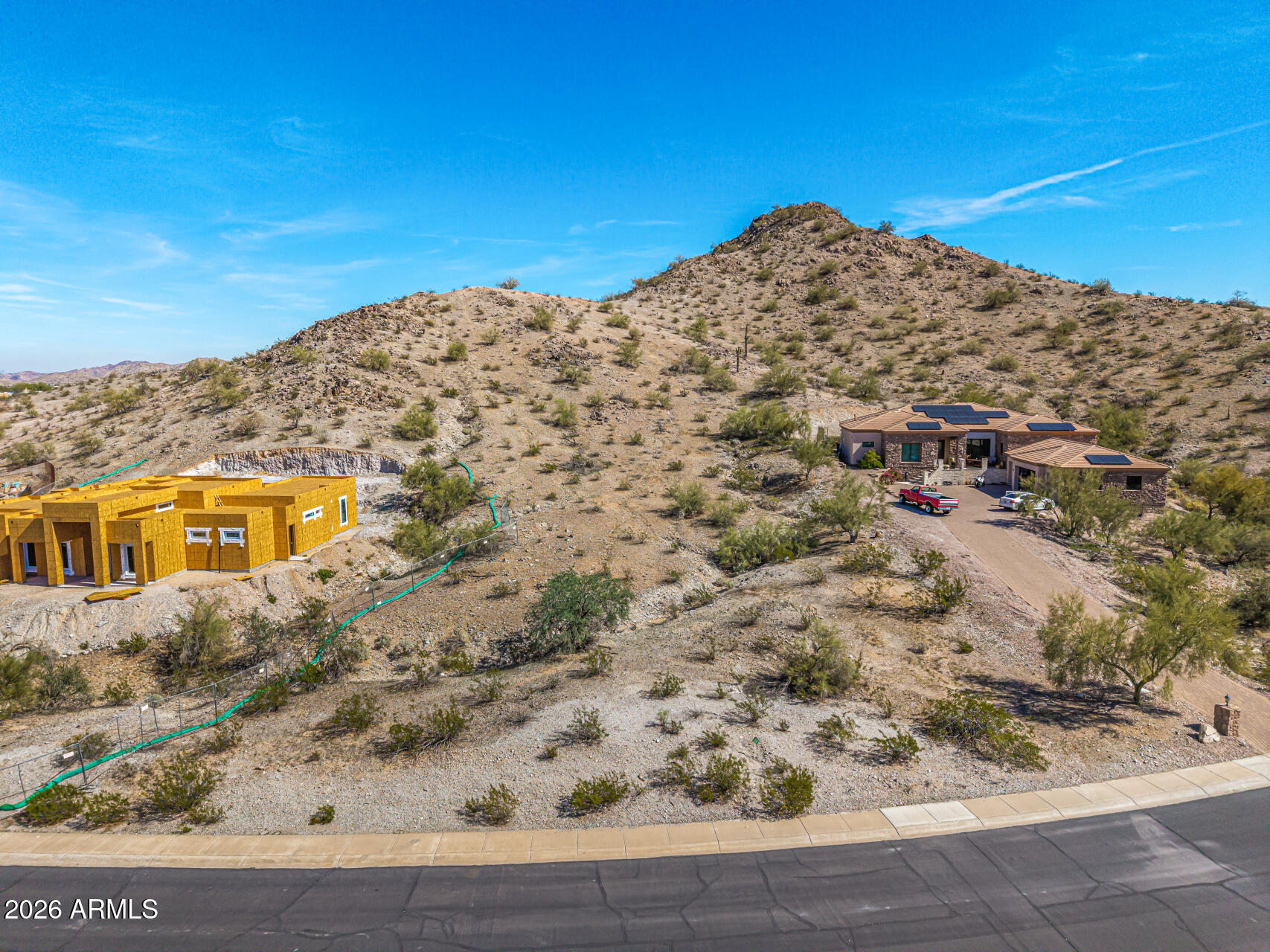 Rare opportunity to secure a hillside homesite in the sought-after master-planned community of Estrella Mountain Ranch! Nestled along the foothills of the Estrella Mountains, this custom lot captures expansive views and enjoys added privacy by backing to open land. Utilities including water, electricity, and gas, are already available at the property, simplifying your build process. Located near South Lake and just minutes from the community's extensive amenities, this property offers the ideal setting to design a home that reflects your vision and lifestyle. Don't let this incredible value pass by!