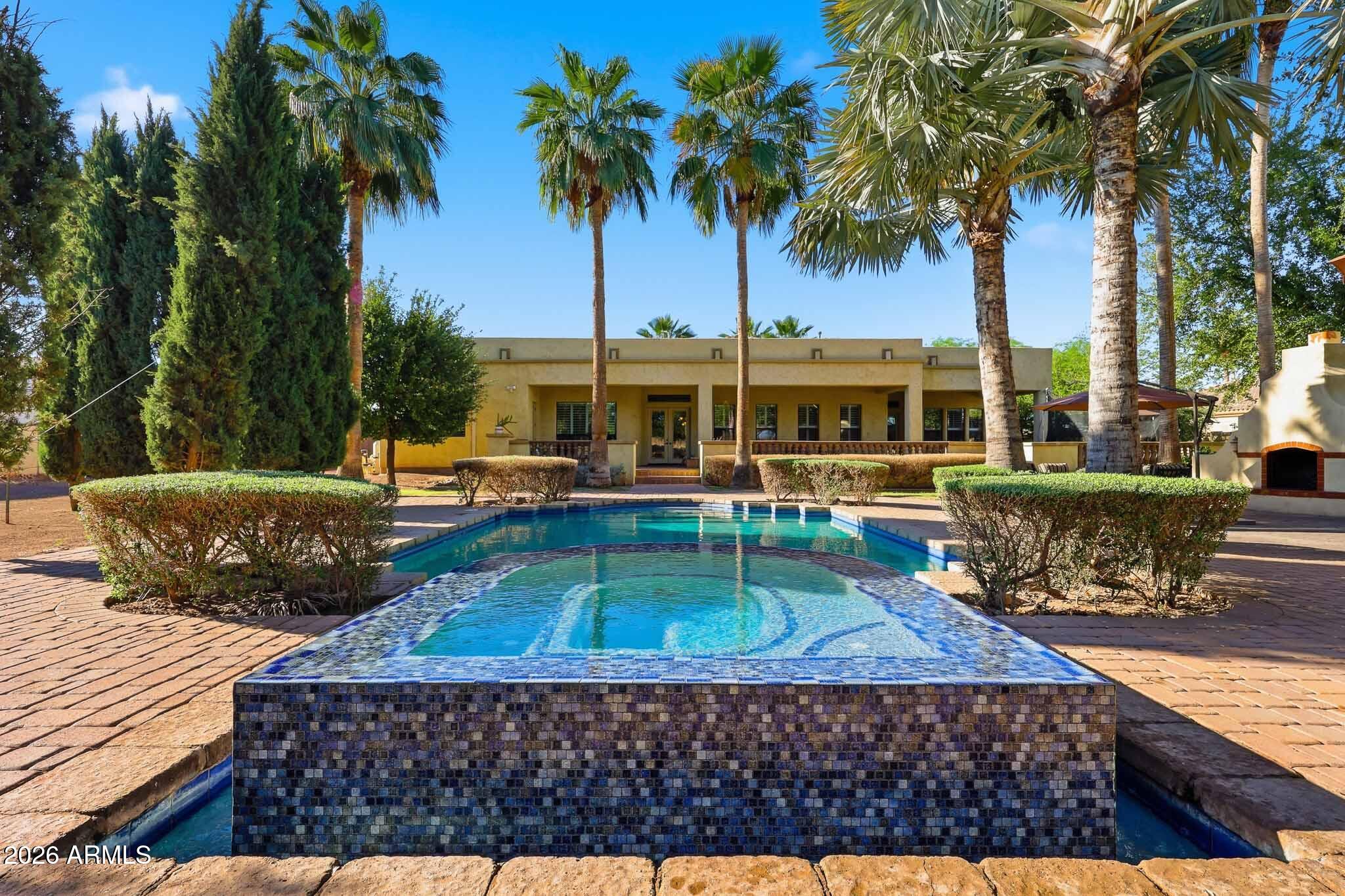 Elevate Your Lifestyle in This Stunning Tuscan-Inspired Estate! 

Step into timeless elegance with this breathtaking 3-bedroom plus den (opt 4th), 3.5-bathroom Vanderbilt Farms custom home offering over 3,600 square feet of refined living space on a 1 acre irrigated homesite. 

Designed to capture the warmth and romance of a rustic Tuscan villa, this residence blends old-world charm with modern luxury.
From the moment you enter, soaring 10-15-foot ceilings create a sense of grandeur, while rich textures and natural materials establish an inviting, sophisticated atmosphere throughout.

Interior Highlights: Interior Highlights:

·  Solid Alderwood cabinetry offering warmth, richness, and custom craftsmanship

·  Commercial-grade KitchenAid appliances for exceptional culinary performance
·        Elegant granite countertops that enhance both beauty and functionality
·        4-piece tumbled and chiseled Turkish travertine flooring throughout
·        8-foot solid core doors providing a seamless, upscale flow
·        6" white wood shutters throughout, adding timeless style and light control
·        2x6 construction with R-21 wet cellulose wall insulation and R-50 attic insulation for superior energy efficiency
·        5/8" solar board sheathing across the entire home for enhanced thermal performance

Outdoor & Lifestyle Features:
·        Over 10,000 sq. ft. of old-world pavers creating a stunning, cohesive outdoor environment
·        Resort-style Pebble Tec pool with a negative edge spa for a true luxury experience
·        Expansive outdoor kitchen with oversized bar seating--perfect for entertaining
·        Extended covered patio spanning the rear of the home, set on an elevated deck overlooking the resort-style backyard
*        Grand outdoor fireplace for relaxing evenings and gatherings under the stars
·        Dedicated garden area with five raised beds for fresh herbs and vegetables
·        Mature fruit and nut trees, including tangelo, white grapefruit, apple, pecan, olive, pomegranate, lime, and multiple lemon varieties

This exceptional property offers the perfect blend of luxury, comfort, and natural beauty--creating a private retreat designed for both everyday living and unforgettable entertaining.

Opportunities like this are rare. Don't let it slip by...