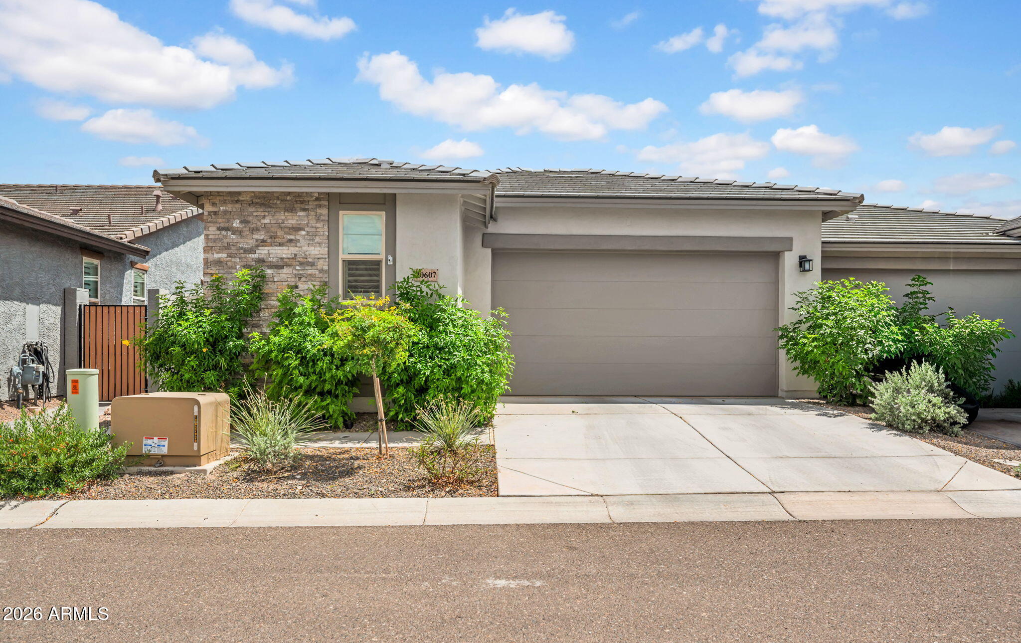 Welcome to resort-style living in the highly sought-after Victory District of Verrado, an exclusive 55+ community designed for comfort, connection, and elevated everyday living. This beautifully upgraded single-level residence offers an open-concept floor plan filled with natural light and thoughtful design throughout. The private split-bedroom layout creates the perfect balance of comfort and privacy, while both bathrooms feature walk-in showers and the spacious primary suite includes dual sinks and a spa-like feel with a therapeutic step-in tub.
With over $40,000 in thoughtful upgrades and enhancements, this home has been elevated well beyond builder standard. Features include plantation shutters throughout, custom tile flooring replacing all bedroom carpet, epoxy garage floors a tankless water heater, whole-house soft water system, and an under-sink reverse osmosis drinking water system. Entertain effortlessly with wired surround sound featuring five ceiling-mounted speakers, upgraded ceiling fans with remotes, and an inviting outdoor space complete with expanded paver walkways and patio areas. Additional improvements include a custom front entry gate, freshly painted exterior, upgraded kitchen faucet, and newer washer, dryer, and refrigerator all included.
Enjoy access to the exclusive Vic Club featuring multiple resort-style pools, pickleball and tennis courts, bocce ball, fitness center, yoga studio, art studio, spa, restaurant, billiards, and countless social activities. Victory residents also enjoy access to the greater Verrado community amenities, creating the perfect blend of luxury, lifestyle, and community living.