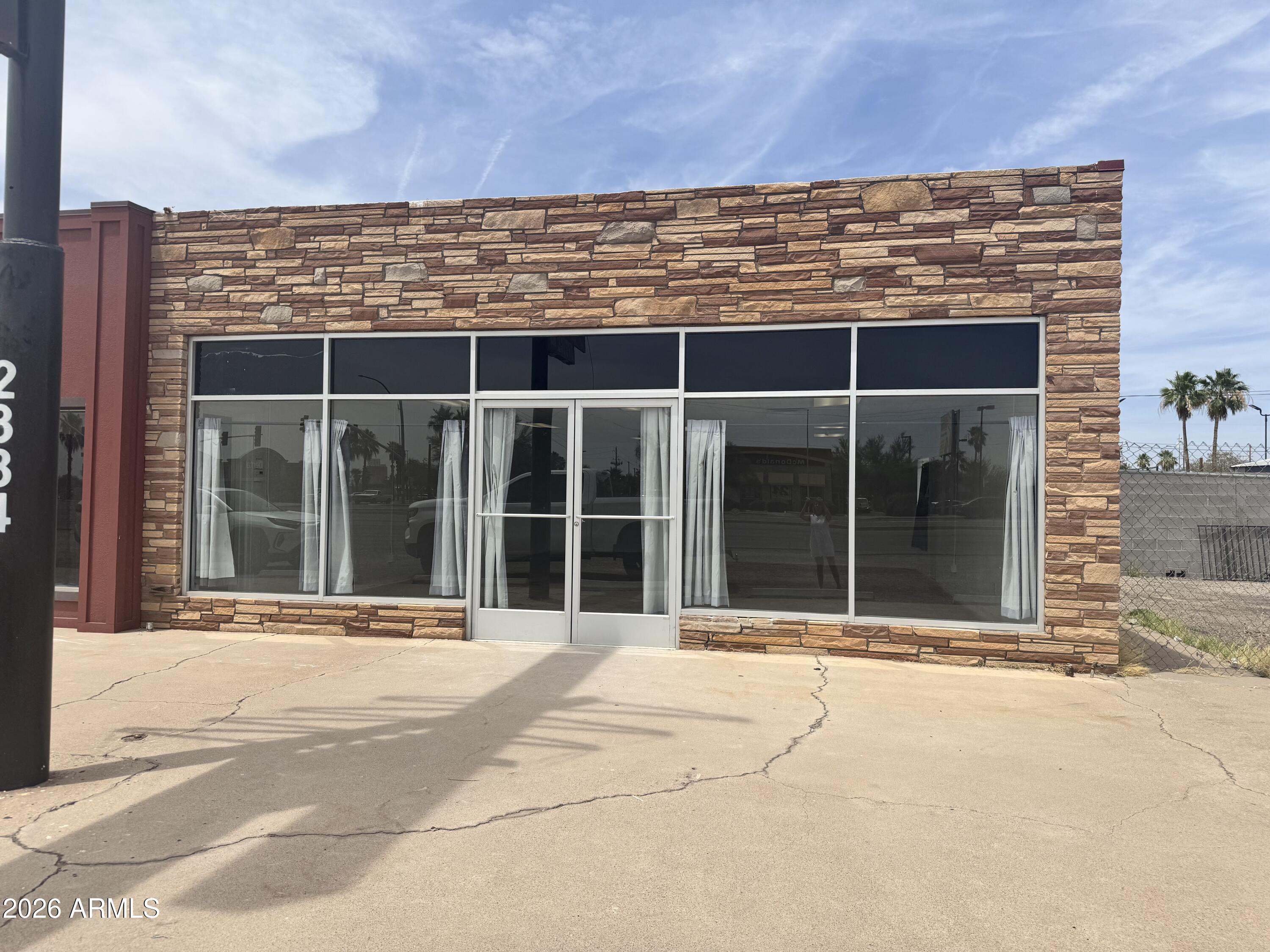 Apache Road frontage. Commercial space with open floor plan. Storage space, two bathrooms and a fenced approximate 35'x35' lot. Street front with windows for visibility. Perfect space for you business potential. Move-in ready.