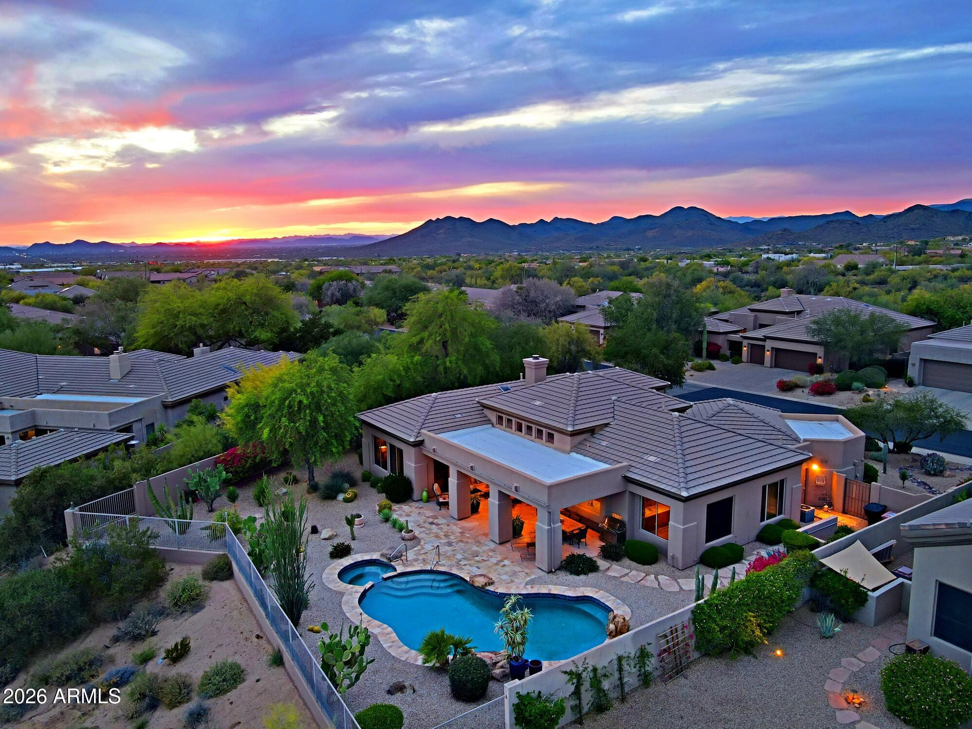 Beautifully located Arcus model on the 3rd hole in Terravita with a sunny South backyard.  Oversized yard with impeccable landscaping combining rock, plants and stoned paving and updated pool and spa with water feature.  Three car/golf garage, 2 bedrooms with den with option for third, 2.5 baths.  Welcoming entrance to open space with formal dining room, great room design and large windows for incredible outdoor views.  Great room has entertainment wall with stacked stone fireplace and large display niches creating a stunning accompaniment to the indoor and outdoor vision.  Convenient seating area with pass through to kitchen.  Ample cabinetry, prep island, stove top, large window over sink for outdoor views, wall ovens, great pantry and a breakfast nook with pass through from/to kitchen. .  Hallway with cabinets takes you to spacious primary bedroom.  Windows have shutters and there is a door to patio.  Bathroom has soaking tub, walk-in shower, separate sinks with vanities, organized walk-in closet. The hallway out of the primary takes you to an optional room for den/office or another bedroom.  The second bedroom is at the front of the home with shutters, linear closet and a bathroom with tub/shower combination and single sink vanity.  There is a "flex" room off kitchen and garage area for multiple uses and contains counter with sink and cabinets plus laundry area.  Backyard:  Oversized with stoned areas including side walkways, pool and spa with water feature, covered patio area with multiple seating space, rock/plant/mature trees including citrus.  Immaculate maintenance and breathtaking view!  A must see!