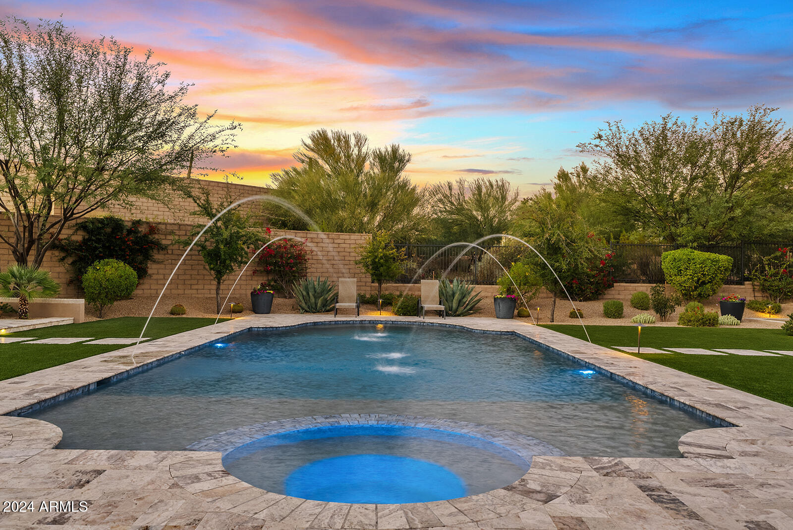 Welcome to White Horse, one of North Scottsdale's most sought-after private, gated communities. Built by Camelot Homes in 2020, this true modern farmhouse combines luxury and comfort, featuring 4 bedrooms, 4.5 bathrooms, a flex room, and a private office. The entry makes a stunning first impression with a serene courtyard water feature, offering the perfect backdrop for breathtaking sunsets. Inside, soaring ceilings and white oak flooring set the stage, while carefully chosen design elements reflect the high-quality craftsmanship Camelot Homes is known for. The home also includes custom lighting designed by Hinkley's Lighting, adding a sophisticated touch to every room. The gourmet kitchen is a culinary dream with Wolf and Sub-Zero appliances, white shaker cabinets, quartzite + soapstone countertops, plus a dedicated wet bar equipped with a wine fridge and ice maker, perfect for entertaining.

The spacious primary suite offers a spa-like retreat with modern fixtures, a soaking tub, marble countertops, and a custom walk-in closet. The rare Etalon floorplan features a split layout, with two guest bedrooms and en-suite bathrooms plus a versatile flex room. An additional guest bedroom with an en-suite bathroom is located on the opposite side of the home, along with a private office with access to the private courtyard. 

Technology and design seamlessly integrate throughout this home, with AV enhancements by Cyber Sound and custom window treatments installed throughout. The 4-car garage is designed with built-in cabinetry and temperature-controlled air conditioning, making it both functional and versatile.

Step outside to a resort-style backyard with McDowell Mountain views to the east. The north-facing yard includes a sparkling pool and spa by Presidential Pools, a cozy fire pit for chilly Arizona evenings, and a mini sport court that can be used for bocce, putting or even cornhole. Also featuring a built-in BBQ for the outdoor chef, while the lush landscaping creates an inviting outdoor oasis.

Located in the heart of North Scottsdale with A+ schools, this home is just five minutes from the Loop 101 offering easy access to everything Scottsdale has to offer, including world-class golf courses, and shopping and dining destinations like Kierland Commons and Scottsdale Quarter. Living in a meticulously crafted White Horse home truly offers everything you need to experience and explore one of the most desirable areas of the Valley.