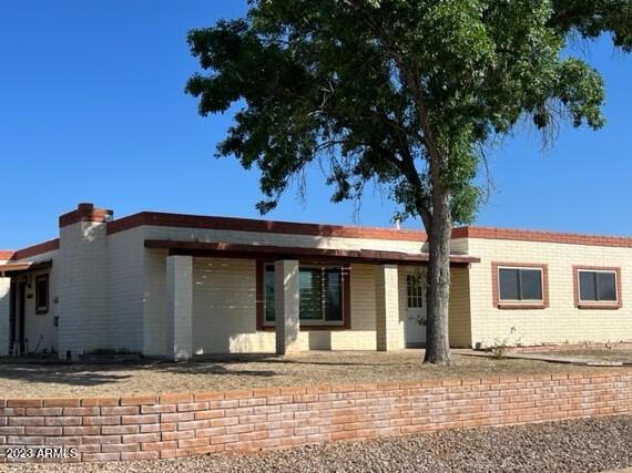 PRICE REDUCTION! Beautiful REMODELED HOME located on a large 1/4 acre corner lot with NO HOA! Block fence, RV gate, covered back patio and more! The oversized kitchen boasts Granite countertops, a large island including a  breakfast bar and SS refrigerator and range. Plenty of counter and storage space here! Enjoy the beautiful beamed ceiling in the step-down living room along with the fireplace and built-in bookcases. Both bathrooms have been remodeled! The master has a large walk-in closet and a private exit onto the covered back patio. Beautiful tile or wood laminate through out the home - NO Carpet!  Come take a look and see if this is the home for you!