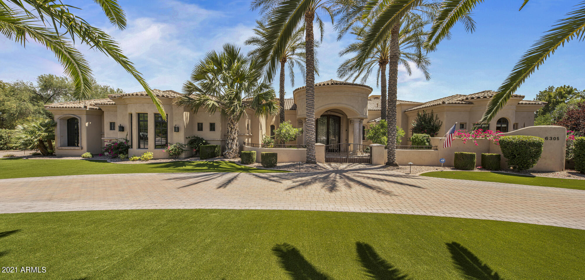 Luxury in abound in this stunning Paradise Valley Estate. This beautiful home has a split floor plan with Master Suite and Large Office off the west wing and 3 en-suites and bonus/game room off the east wing and a detached guest casita by the pool. As you enter into the grand foyer you experience the vastness of the formal living room, dining room and wet bar w/ a 1000 bottle chilled wine cellar. The chef's kitchen is adorned with 4 Viking ovens(2 are wall ovens), Viking range, dual refrigerator/freezers, dual dish washers, 2 islands, vented hood, built in Miele expresso maker, farm sink, drawer microwave, butler and walk-in pantries. The large Master Retreat boast a sitting room, a door leading out to rear yard pool/spa, gas fireplace, 2 walk-in closets with one plumbed for washer/dryer. The Master Bath is your personal spa with 2 vanities, 2 water closets, steam shower with rain head, and amazing 2 person jetted tub over looking an atrium. The home is equipped with a Crestron system that works the lights, pool equipment, exterior shades, commercial grade misters ect... The family room is open to kitchen with a large exterior pocket door that opens to the covered patio and out door kitchen. The resort style back yard has a custom pool and spa with travertine pavers, many water features. The 1 room guest casita has a full bath with separate entrance to be used as a pool bath. There is a built-in curved seating area around the gas fire pit. There is a gated entry into the motor court area that is large enough to store an RV. The side entry air conditioned 4 car garage has high ceiling that could accommodate car lifts. There are 2 Electrical Vehicle charging points in the garage as well. Owner has recently installed turf in the front and rear yards and has replaced all of the HVAC units including the wine cellar. They have also installed 2 tankless water heaters in the main house. The home has enterprise-grade wireless network. This super unique estate is a must see!!