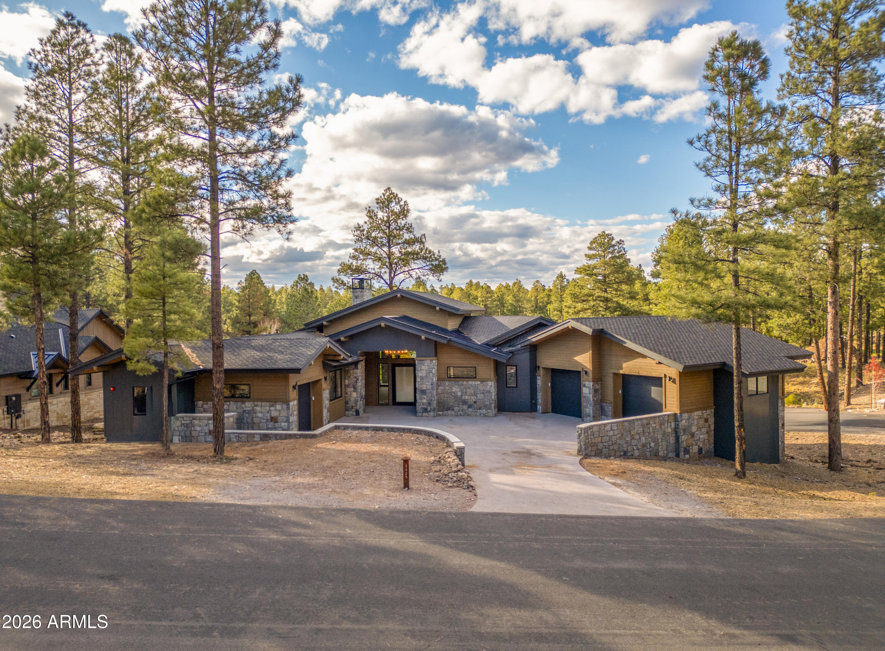 This new home in Flagstaff's premiere private golf community is now MOVE IN READY! Discover unparalleled elegance in the heart of Pine Canyon. Boasting three primary suites, two expansive outdoor patios/decks, a private study, and two massive living spaces, this precisely curated mountain retreat combines the natural beauty of the pines and peaks with an unmatched lifestyle of luxury. Experience refined finishes and materials such as Quartzite, Crema Marfil Marble, backlit Onyx, ambient/accent lighting, rift-sawn oak millwork, hardwood flooring, premium European Grohe plumbing fixtures, motion activated under-vanity lighting, heated bathroom floors, and so much more. The builder, AZ Royal Granite, continues to build homes in Pine Canyon with the highest level of pride and craftsmanship.