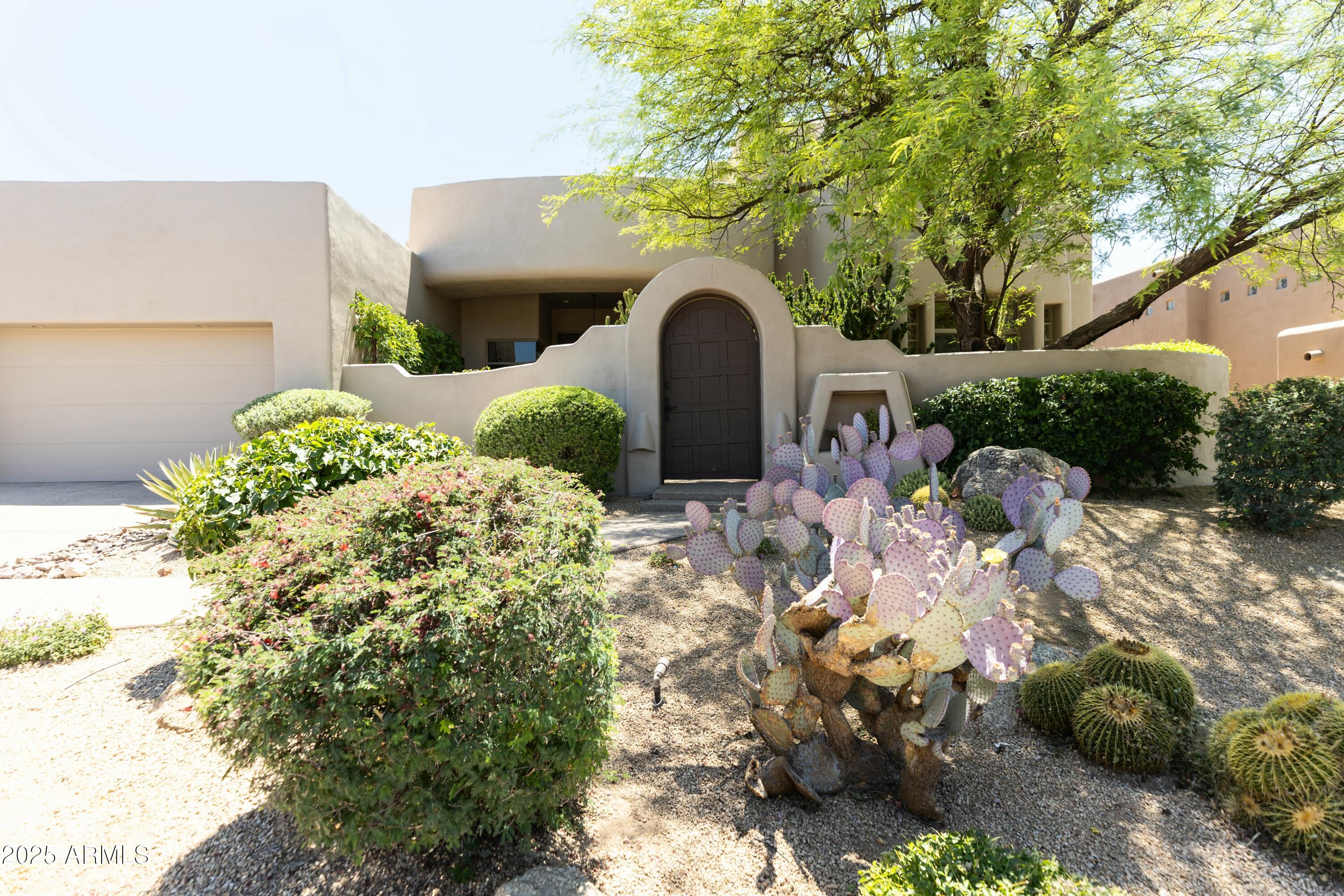 This home, designed by the award-winning interior design firm Living with Lolo, has been proudly featured in Modern Luxury Interiors, showcasing the exceptional style & craftsmanship. This exquisite residence, a custom built modern southwest home, underwent a stunning transformation in 2024 by a top Interior Design Firm. With most of the living space on the first floor, including owner's suite, two additional bedrooms with en suites, an office, and full powder bath, upstairs you'll find the perfect space for guest quarters and/or game room. 

The spacious and open floor plan seamlessly blends contemporary design with the charm of the Southwest. The heart of this home is it's chef-inspired kitchen, boasting custom cabinetry, sleek quartz countertops and high end appliances. Whether you're preparing a gourmet meal or simply enjoying your morning coffee, the kitchen offers beautiful views that extend into the expansive great room. Beyond lies a panorama of natural beauty, with vistas of Troon North's Pinnacle golf course, Pinnacle Peak, and breathtaking sunsets views. 

The owner's luxury sanctuary includes a spa-like bathroom and private outdoor sitting area, meticulously designed for comfort and indulgance. 

The two additional bedrooms on the first floor each have their own private bathrooms and walk-in closets.

The upstairs guest space is accessible via an elegantly curved staircase and features a living space with wet bar, bedroom and full bath. The balcony offers stunning views of Pinnacle Peak, the golf course and city lights.

This home is an entertainer's dream, blending awe-inspiring views, exclusive privacy, and the prestige of residing on the Troon North Pinnacle Course. Discover a home that not only meets the highest standards of modern luxury but also captures the essence of Arizona's unique beauty. Welcome to an elevated lifestyle where every detail reflects the pinnacle of sophistication and refinement.
