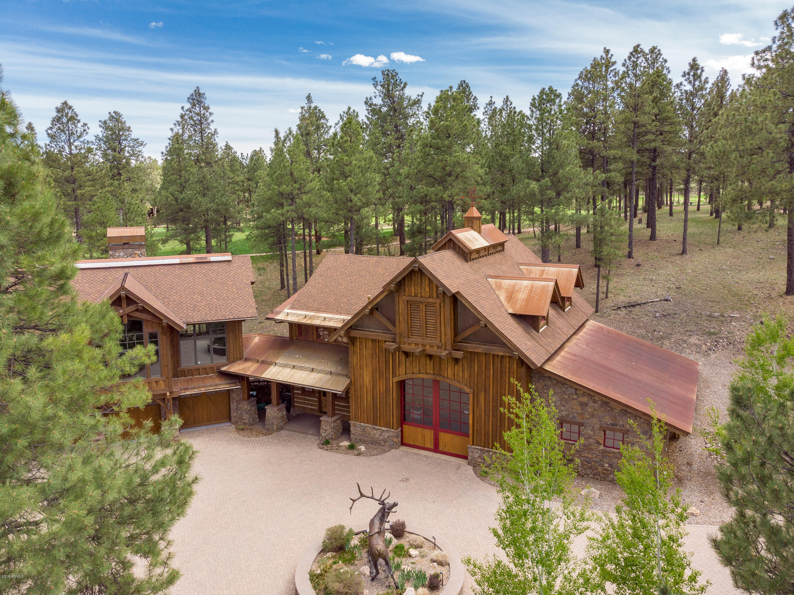 The Champion of Estates within the private guard gates of Pine Canyon.  The serpentine paver drive is northing short of grand entrance arriving to the barn also known as a ten car garage!  The private enclave captures complete privacy, 1.2 acres and panoramic golf and lake views!  
The home creates a cozy, sophisticated cabin feel however boast soaring ceilings, extensive glass, fold away doors and a flowing stream that is a show piece from the dining, great room and master quarters. 
The home lives as a single level, however the secondary rooms are upstairs and a stunning game/billiard room.  The luxurious apppointmens include a carved granite soaking tub, stacked stone, designer flooring, hand cut log walls.  The finishes, quality and location remain the best of the best of Pine Canyon The entertainment pavilion offers a second level fully equipped private home theater, a powder bath workshop and a flexible heated barn space that can accommodate 10-12 cars, a play area, indoor tennis or additional gaming area. It is designed with the finest finishes and barn doors from and old horse barn in Kentucky to impress your even most discerning guests. 

Timeless Luxury Estate in the pines.