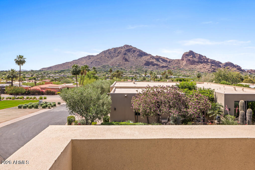 Experience ''Colonia's Crown,'' the pinnacle of Paradise Valley living in the prestigious, guard-gated community of Colonia Miramonte. Perched atop the neighborhood, this sophisticated residence offers 3,338 total sqft of refined living space, beautifully positioned between the iconic Mummy and Camelback Mountains. The home welcomes you through a sprawling, private courtyard that sets a tone of secluded relaxation. The 2,928 sqft (2 bed/2 bath) main home features an elegant living area furnished with French Oak flooring and a regal fireplace. The chef's kitchen is tastefully designed, featuring a Bertazzoni Italian range, premium granite countertops, and a wine fridge. (continued in supplement remarks) Every bedroom, including the spacious primary suite complete with a dual-vanity and soaking tub, offers direct access to the lushly landscaped grounds through charming French doors. For a truly elevated experience, the versatile "sky loft" provides a premier vantage point for breathtaking panoramic views of Camelback Mountain and city lights. The property includes a private 410 sqft guest casita (1 bed/1 bath), ideal for visitors or a home office. Significant updates include the full replacement of two HVAC units, new flooring in the primary suite, beautiful doors in bedroom two, and the addition of a half bath in the sky loft. Residents of Colonia Miramonte enjoy a lifestyle like no other including "yappy hour" at one of the neighborhood parks, live acoustic performances, and exclusive perks at the Camelback Inn, such as white-glove room service delivered straight to your door. Whether seeking a year-round residence or a lock-and-leave retreat, this is Paradise Valley living at its finest.