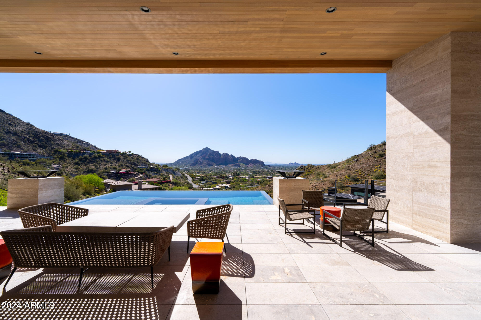 A perfect hillside contemporary home designed by CP Drewett of Drewett Works and built by Sonora West Development. This stunning home could not have a better pedigree, and it shows. The warm stone and wood finishes perfectly compliment the minimal design. Every room has an unmatched Camelback or Preserve view. The only way to experience properly is to see it in person.