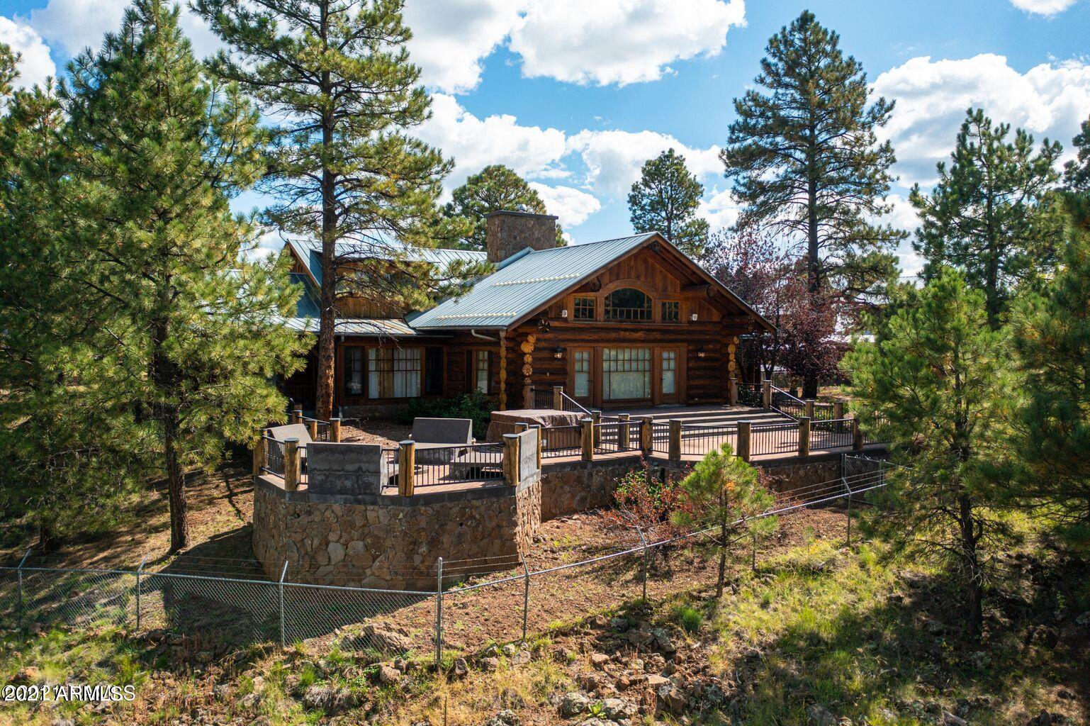 The Sky Ranch is on elf the most incredible TURN KEY equestrian estates in Northern Arizona. Located in the breath taking community of Parks, minutes from Flagstaff, Williams and about an hour from the Grand Canyon. This custom log home backs National Forest on two sides, is walking distance to Shultz lake, and is surrounded by riding trails that go for what feels like forever! The main house has 4 bedroom 4 bathrooms, master on the main, work out/yoga room and an impressive executive office. The cabin boasts 4,800 soft of hand made custom windows and doors all with the views and wilderness in mind, the logs throughout the home are hand-hewn skip peeled pine, and the Malapai rock was locally sourced. There is Russo Peters CUSTOM made cabinetry in the kitchen, executive office, and throughout the home. The guest house 700 sqft 2 bedroom, 1 bathroom with a full kitchen and amazing views of the peaks. The property has it all; 24 acres full fenced with access to the forest, HUGE 5 car garage with a work shop, a 80x140 sf. INDOOR arena, there is a 7 stall barn made with Mortise and tenon timber from a 125-year-old reclaimed Army barrack, and pasture that would make any horse's dreams come true. This property is special and was so loved that it shows from the moment you walk onto the land. Schedule a showing today, once you sit on the front deck you won't ever want to leave.