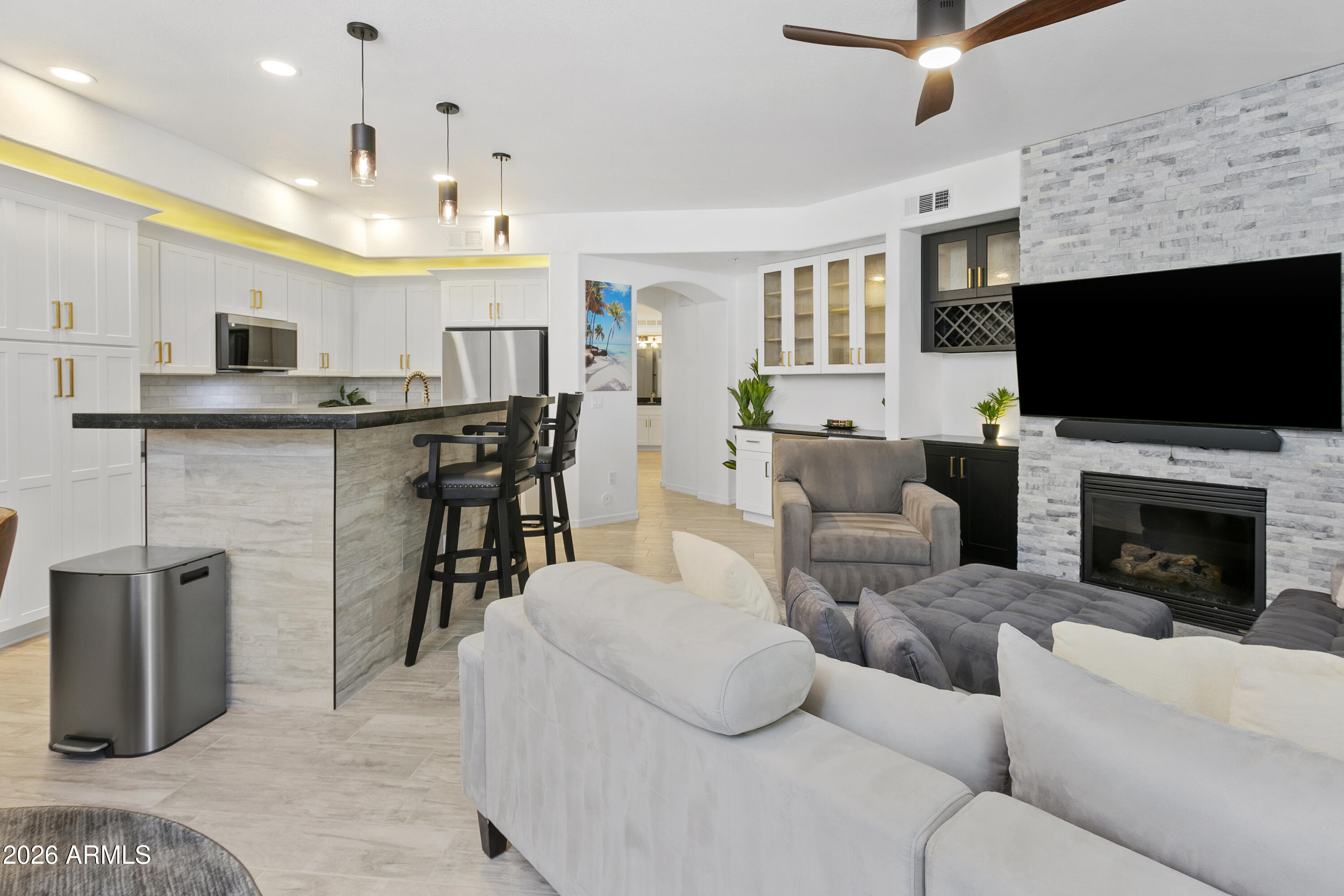 2025/2026 full remodel ground level prime location poolside unit with rare 2 car tandem parking spots and 8x5x4 garage storage locker.  New Smart Samsung Bespoke appliance package (control with phone app) including autofill water pitcher refrigerator, gas cooktop dual door range, micro, dishwasher, washer & dryer.  New Black Mist Granite Counters throughout and new extensive white shaker cabinetry throughout for abundant storage including soft close doors & drawers throughout.  New Wood-look plank tile throughout (no carpet).  New brushed gold faucets, fixtures and cabinet pulls.  Full desk office center and additional beverage center with wine storage cabinetry.  New LED flush mount dimmer ceiling lights throughout in/out.  New Decor light switches & outlets throughout. Ledgestone tile gas fireplace with new ebony shaker TV-fireplace cabinetry.  New bath & shower tile throughout including rain shower, handheld shower, new frameless glass shower door. and new dual flush toilet.  New bedroom-bath privacy barn door.  New plumbing to fixtures and garbage disposal.  New tankless water heater allowing additional storage in patio closet.  Full TRANE AC system, Ecobee smart thermostat and new registers/vents throughout.  New drapes & blinds throughout.