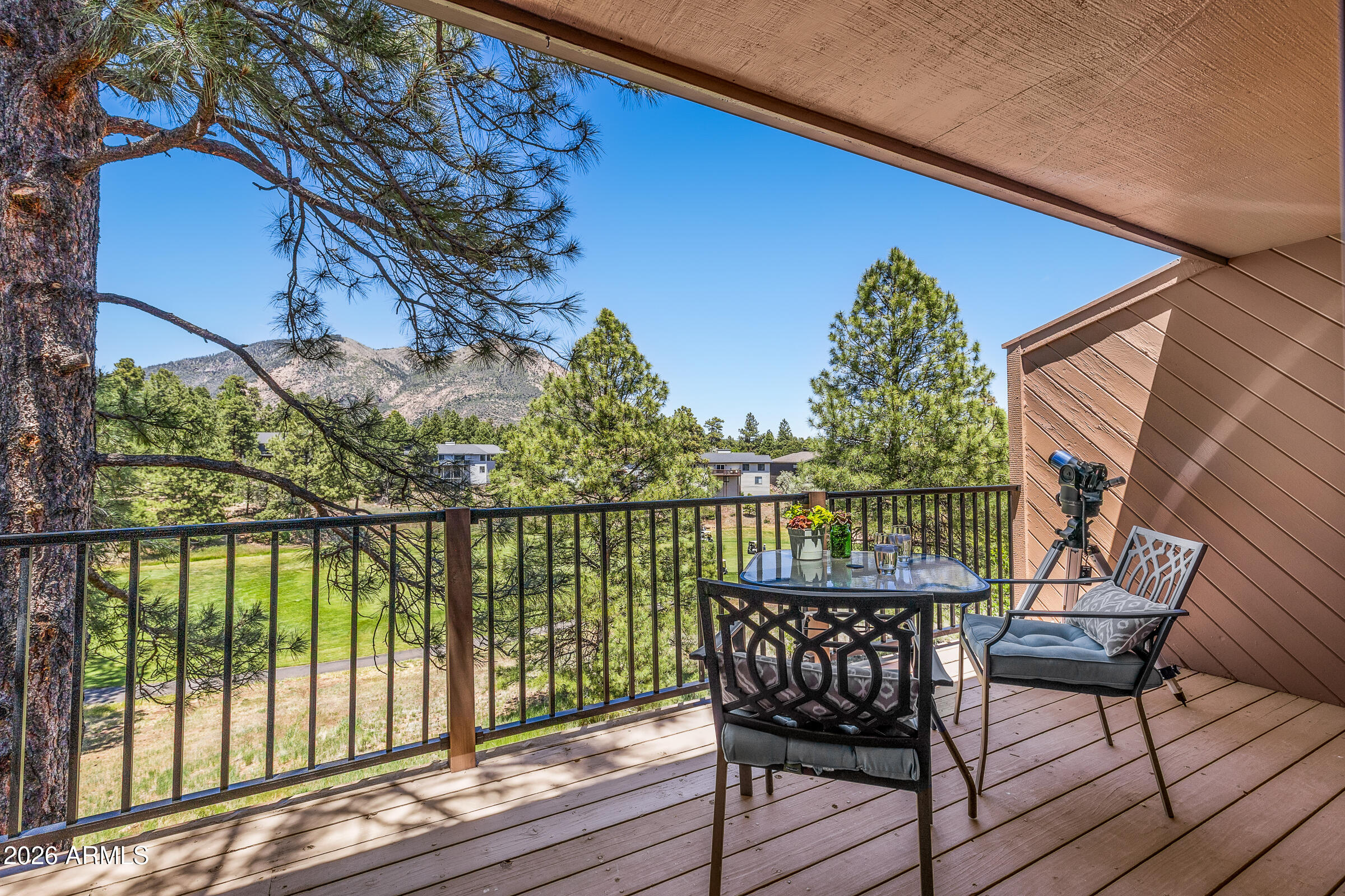 Welcome to a low-maintenance lifestyle in Continental Country Club, ideal as a full-time home or easy, lock-and-leave for a cool, summer retreat. This well-cared-for owner-occupied townhome offers the rare combination of both Mt. Elden AND golf course views in one of Flagstaff's premier golf communities. Thoughtfully updated, this 3-bedroom, 2.5-bath home overlooks the 13th fairway of Aspen Valley Golf Course. Two private decks provide the perfect setting to enjoy morning coffee, watch local wildlife, and take in the peaceful mountain surroundings.
The open main level features REAL oak hardwood floors, a refreshed kitchen with breakfast bar, and a cozy stone fireplace. The primary suite includes an updated en-suite bath and walk-in closet while two additional bedrooms upstairs feature walk-in closets, and one offering its own en-suite. Designed for easy, low-maintenance living, the HOA covers exterior landscaping, roads, painting, and roofing, including a new roof in 2025.  Enjoy access to Continental Country Club amenities with the optional upgrade fee (see HOA addendum)-golf, pickleball, tennis, swimming, exercise room and the Bear Paw Recreation Center.  This owner-occupied home is ideal as a full-time residence, seasonal retreat, or carefree mountain getaway. NOTE: Owner/Agent