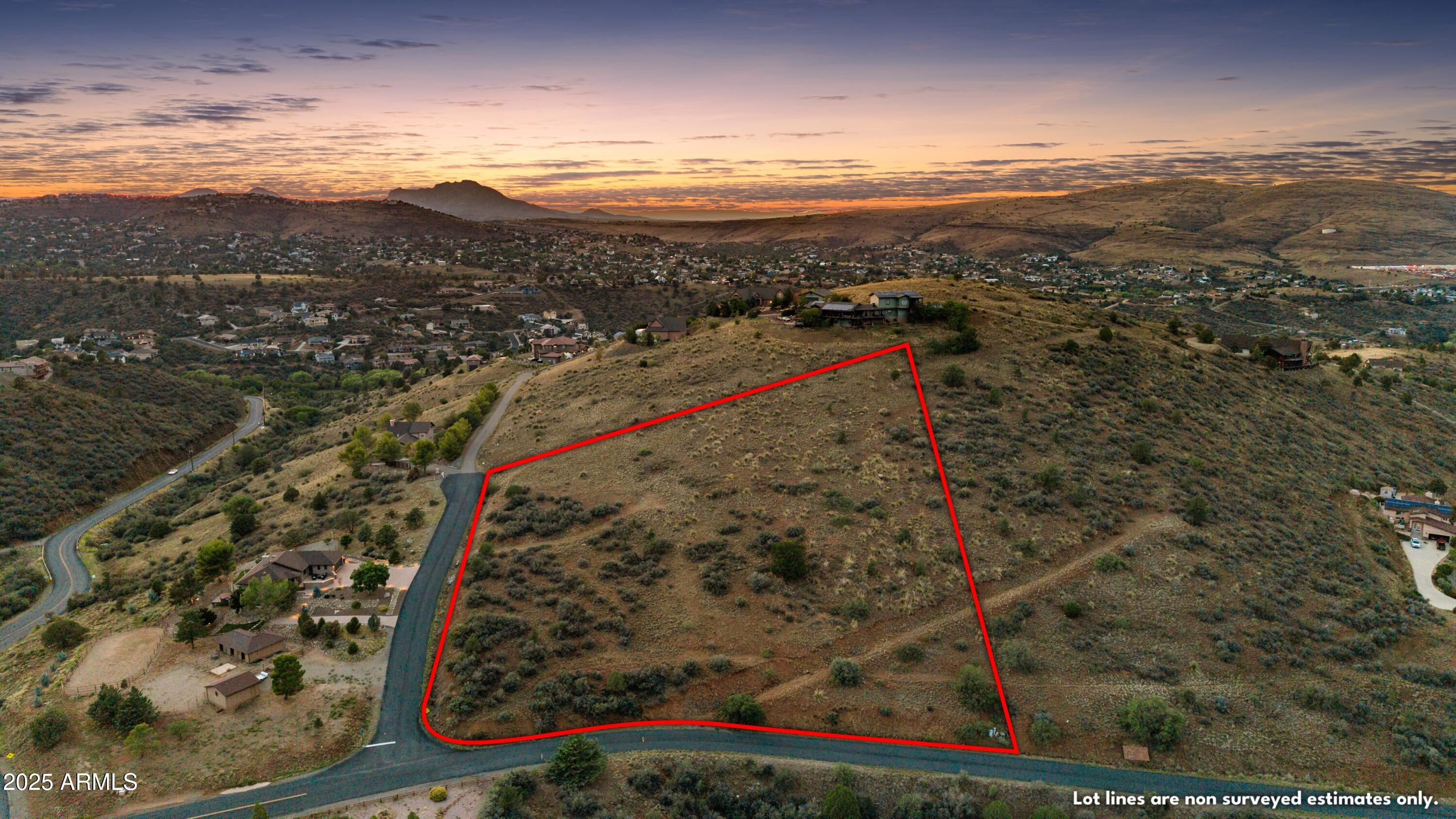 This exceptional 3.47-acre homesite, located in the prestigious Lynx Mountain Estates, offers a rare opportunity to build your dream home in a sophisticated, serene mountain setting. A corner parcel on a peaceful cul-de-sac, with paved roads. The property boasts breathtaking 360-degree views of the surrounding mountains and the twinkling city lights of Prescott and Prescott Valley at night. The site is ideal for those seeking solitude without sacrificing convenience. Only a short drive from the vibrant Historic Downtown Prescott, you'll enjoy the best of both worlds - privacy, natural beauty, and easy access to shopping, dining, schools and medical care. Lynx Mountain View Estates boasts custom homes, with building restrictions that ensure the neighborhood retains its exclusivity. Underground utilities are at the property line. Acres and Acres of National Forest to the south for the hiking, equestrian, and gold panning enthusiasts.