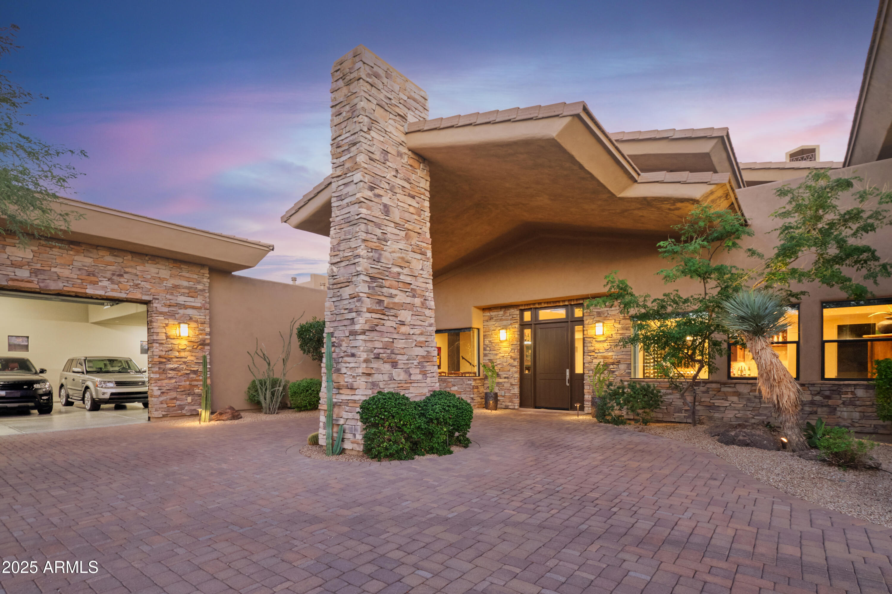 MAJOR PRICE REDUCTION!!!  Attention Car Collectors and Wine Enthusiasts!!! This home has exactly what you are looking for! This highly upgraded home homes boasts exceptional mountain views, elevated star gazing and sweeping sunsets from its wrap around patios which overlook the resort style pool and spa. As you step inside this multi-generational home you be impressed by the 900 bottle glass wine cellar, intimate home theater, wet bar, and mezzanine game room. The spacious kitchen features all of the high end SubZero, Viking and Wolf appliances. The light filled primary suite has direct patio and pool access, glass shower, soaking tub, and spacious closet. There are 4 additional guest ensuite bedrooms in addition to a 2 level attached quest casita. Each quest room has its own patio ...... The sprawling patio features a fireplace, pool bathroom with shower and a full outdoor kitchen with a huge grill, pizza oven and a Big Green Egg. The car collector's DREAM GARAGE has room for at least 6 cars and more with lifts. Design what fits your needs in the 30ft x 60 ft space with a 13 ft ceiling height. 
Please see list of improvements in the Documents Tab