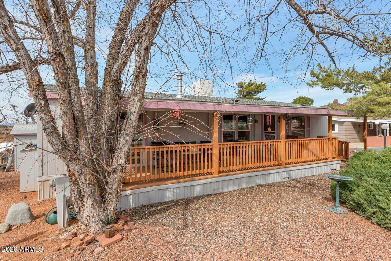This newer manufactured home is situated in the heart of West Sedona and offers 1,456 square feet of living space, featuring three bedrooms and two full bathrooms. The living room includes a gas-burning fireplace, providing a cozy atmosphere. Located within a vibrant 55+ community, residents enjoy access to amenities such as a clubhouse, heated pool, pickleball courts, mini dog park, regular social gatherings, and a food bank available twice a week.

The primary suite offers comfort and convenience, featuring a spacious walk-in closet, dual sinks, a separate shower, and a handicap-accessible bathtub. Additionally, the home boasts a recently installed roof (2023) and fresh exterior paint, ensuring durability and a polished appearance, and new hot water tank. A large storage shed provides ample space for personal belongings, while the corner lot delivers scenic views that enhance the overall appeal of the property.  Large covered deck in front of house to enjoy the great outdoors!

No rentals are allowed in this subdivision.
