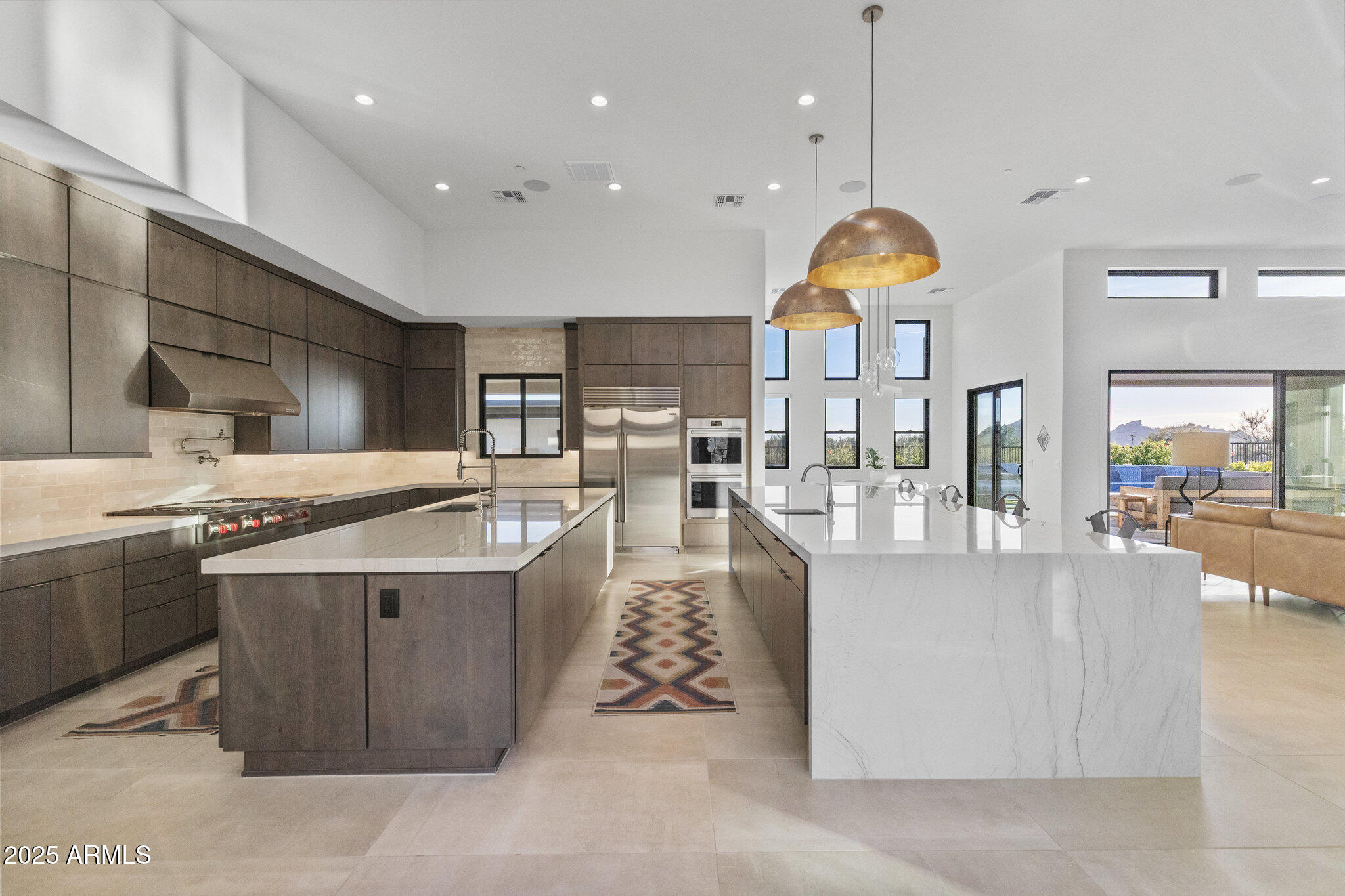 Designed with CAR ENTHUSIASTS in mind, this single-story home with effortless indoor-outdoor flow features a 5-car direct-access garage with room for a sixth car, an RV gate and NO STEPS. Built in 2022, the open-concept floor plan offers elevated ceilings, a chef's kitchen with dual islands and a private interior courtyard. An attached casita as well as additional flex room provides flexible spaces for guests, an office, or a hobby room. The resort-style backyard includes double pools, a heated spa, covered pergola, multiple seating areas and fire features, and panoramic mountain views. Located on an elevated lot on a quiet cul-de-sac within a gated North Scottsdale enclave, close to golf, dining, and outdoor recreation.