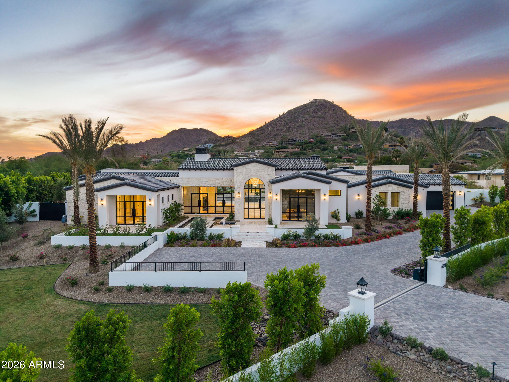 Another brand new move-in ready masterpiece built by Lux Estate Development! Offering world class finishes and stunning Camelback, Phoenix Mountain Preserve and Mummy Mountain views, this stately residence boasts 5 bedrooms, 8 bathrooms + a theater room and sprawling guest house! The gorgeous primary bedroom offers tall ceilings, cozy fireplace + a spa-like primary bathroom with dual vanities, soaking tub, large shower, coffee bar with sauna and 2 spacious closets! Separate office with built-in cabinetry and french doors lead to the front patio. Incredible Kitchen with double islands, Wolf and Sub Zero appliances, coffee maker and a back up kitchen. Stunning backyard with large covered patio with BBQ, sparkling pool and spa with baja shelf, fire pit and outdoor shower.