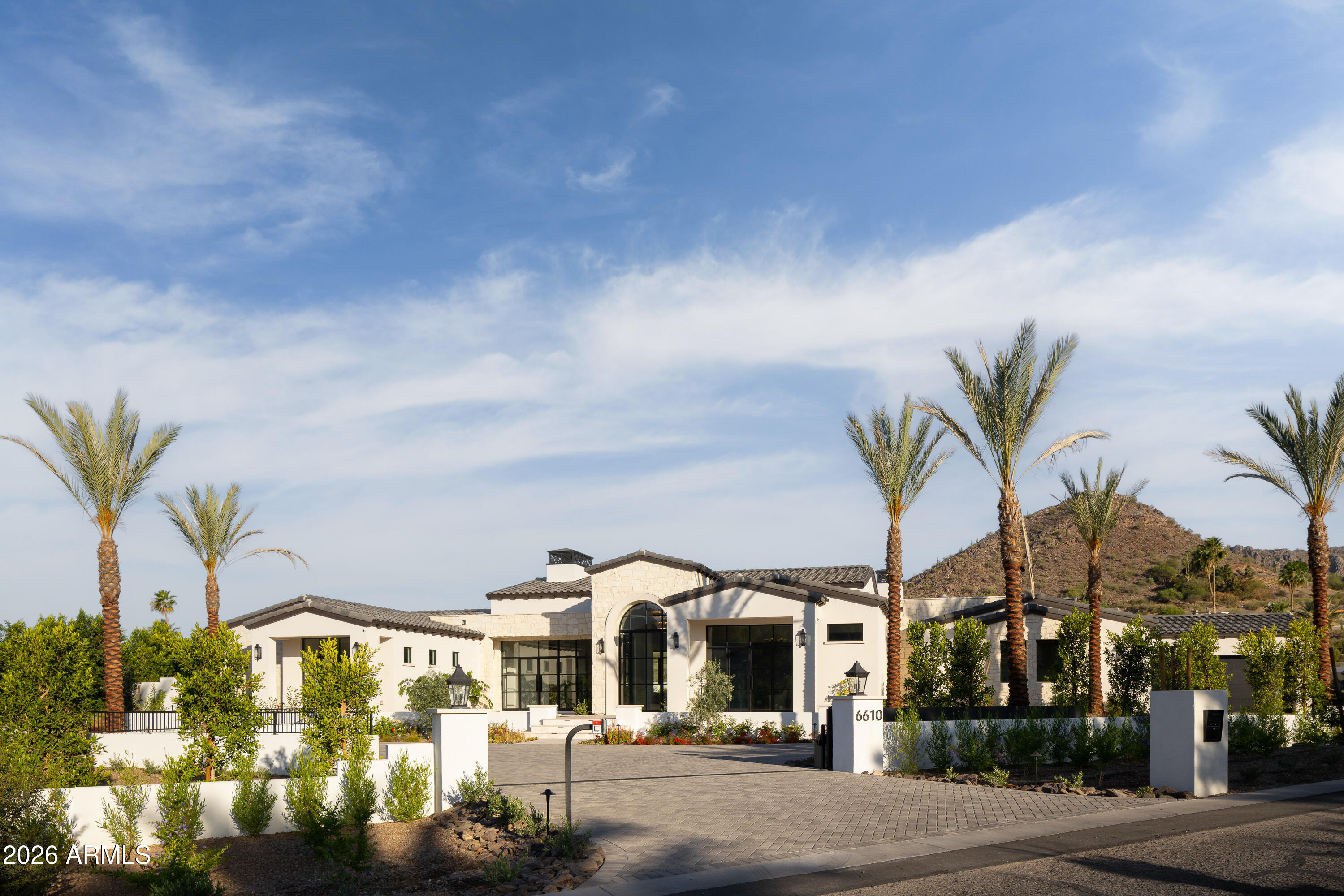 Another brand new move-in ready masterpiece built by Lux Estate Development! Offering world class finishes and stunning Camelback, Phoenix Mountain Preserve and Mummy Mountain views, this stately residence boasts 5 bedrooms, 8 bathrooms + a theater room and sprawling guest house! The gorgeous primary bedroom offers tall ceilings, cozy fireplace + a spa-like primary bathroom with dual vanities, soaking tub, large shower, coffee bar with sauna and 2 spacious closets! Separate office with built-in cabinetry and french doors lead to the front patio. Incredible Kitchen with double islands, Wolf and Sub Zero appliances, coffee maker and a back up kitchen. Stunning backyard with large covered patio with BBQ, sparkling pool and spa with baja shelf, fire pit and outdoor shower.