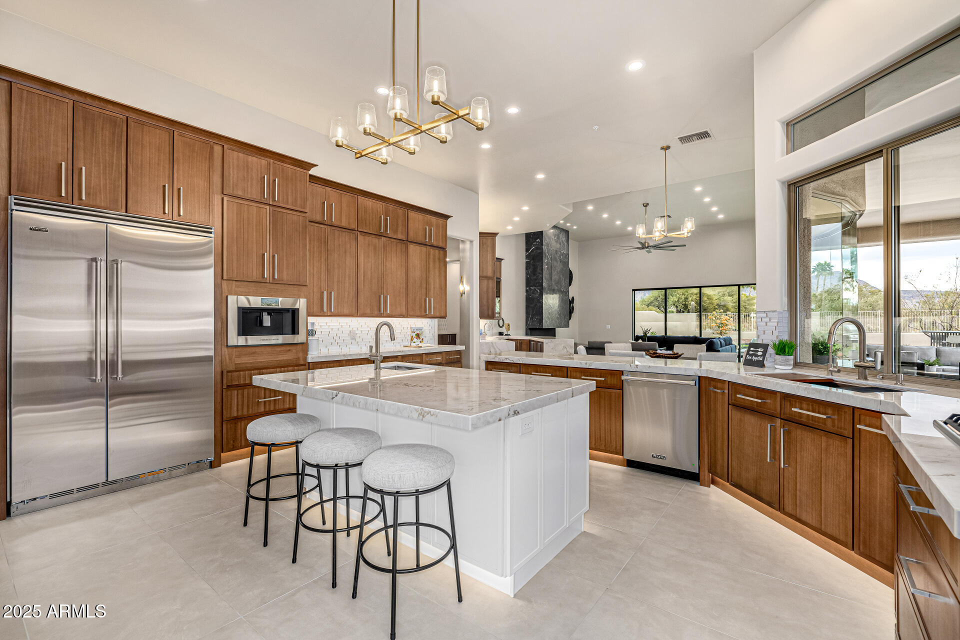 Voted Best Home on the Scottsdale Luxury Realtor Tour!! An extensive remodel & transformation make this feel like a new custom home. You will love the luxury lifestyle it provides, the use of the latest design elements, high quality workmanship & amazing attention to detail. It is the home you've been waiting for! Located in the exclusive Catavina Foothills neighborhood. Perfectly situated at the end of a Cul de Sac that is far from busy streets w/only one adjoining neighbor. The orientation of this the very private lot boasts gorgeous Mountain Views on a huge parcel of land that is almost an acre in size. This Single Level home features a very desirable floorplan with 4,604 SF, 5 Bedrooms, 3.5 Baths, Large Bonus Room & 4 Car Oversized Garage. The roof tile & underlayment were replaced 2 years ago. 2 new Trane HVAC systems were just installed! Refreshed landscaping, new outdoor lighting & new exterior paint provide great curb appeal. There's plenty of parking for your guests with the wide driveway leading to the garage & RV gate plus an additional large circular driveway for your guests. There is plenty of room in the side yard for all your "toys". 

Upon entering the new impressive custom iron pivoting front door, the Living Room is ahead and equally impressive with its 16' coffered ceiling, large windows that overlook the resort style backyard and mountain views.
 
The Dining Room features a new custom Wine Wall that holds 300+ bottles of wine. It has its own cooling system, LED lighting, remote control and custom glass with a locking mechanism. Additional features include a coffered ceiling, wood shutters, new sconces and a gorgeous 2-tier chandelier.

The Kitchen and Dinette are open to the Family Room & Bar, providing a remarkable open entertaining and living space. It offers a large Island with seating, storage, veggie sink, island chandelier and a Viking microwave drawer.  Other desirable features include natural stone Quartzite countertops, a reverse osmosis system, new kitchen sink & faucet, pot filler, a passthrough window to the patio, walk-in Pantry and a Bulter's Pantry leading to the Dining Room. The new soft closing cabinets include crown molding, under cabinet lighting, toe kick lighting, up-lighting, 60" uppers, built-in trash containers, a slide out spice rack and a cookie tray cabinet. The kitchen also features an all-new Viking stainless appliance suite and Fisher & Paykel Built-in Professional Series Coffee/Espresso Maker with LED lighting. A gorgeous glass backsplash, waterfall peninsula & custom hood vent provide a high-end look along with the beautiful natural stone Quartzite countertops. The spacious Dinette offers large bow windows with butt glass that provide lots of natural light and views of the beautiful backyard. 

The Family Room is open to the kitchen and offers a walk-behind lighted bar with seating, a new beverage center, bar sink, waterfall quartzite countertops and lots of cabinetry for storing your barware and so much more. The upper cabinets have glass fronts and floating shelves. The gorgeous new 60" gas linear fireplace is Arizona Fireplace's latest model with a GlowFire burner, reflective glass and an amazing natural looking flame going through the upgraded logs. The fireplace tile design adds additional warmth and design to the room. The 2 new multi-slider doors are each 14' wide and provide lots of natural light, slide to one side for entertaining and bring in the outside with beautiful views of the mountains and resort like backyard. 

The Bonus Room is currently set up as a second family room but can become an exercise room, office, music room, theater or just about anything you can think of. If desired, the room can easily be enclosed. Newly added features include a custom window seat, built-in cabinetry with a Quartzite countertop and stylish wallpaper.

The Primary Bedroom Suite welcomes you with lots of natural light, coffered ceiling, a beautiful newly added Wall Feature with pendant lighting, a gas fireplace, new patio door that exits to the inviting backyard and a new picture window provides a beautiful view of the mountains, pool and resort-like backyard.

The Primary Bath is sure to be a WOW factor! The luxurious walk-in shower features a new designer-style shower surround with a lighted niche & bench, rain shower head plus 2 shower heads, tile accents and custom designed shower glass enclosure. The Primary Bath also includes a separate water closet, new large freestanding tub, his & her soft closing vanities with Quartzsite countertops, linen cabinets, a lighted makeup area, all new faucets, sinks, mirrors, medicine cabinet and bath accessories. 

The new professionally designed Primary Walk-In closet is another WOW factor. It offers a luxurious feel with plenty of features and storage. Closets by Design's top of the line cabinetry is 8' tall with crown molding, backing, slanted shoe racking, sweater/purse shelving, enclosed wardrobe cabinetry, valet bars, belt racks and features an island with a quartzite countertop and 8 large drawers.  

All Guest Bedrooms have large closets, wood shutters, new closet doors and lighted ceiling fans. One guest bedroom is located near the primary suite and is currently set up as an office. The other 3 guest bedrooms are conveniently located on the other side of the home near the bonus room. One bedroom has its own attached bathroom. Two of the bedrooms share a spacious Jack and Jill bathroom. 

The Guest Baths all feature new soft-closing vanities, Quartzite countertops, new tiled shower surrounds with niches, Kohler toilets, sinks, faucets, mirrors, medicine cabinets, hardware, shower doors and new bath accessories.

The Powder Room was completely redesigned and is stunning! You will love the all-new lighted Quartzite vanity, beautiful wallpaper, pendant lighting, toilet, sink, faucet, nickel wall plates, custom floor to ceiling mirrors and tile accents.

The Laundry Room features an Electrolux Washer and gas Dryer with pedestal storage, new soft-closing cabinets, Quartzite countertops, laundry sink, faucet and lighting.

The sprawling Backyard is amazing! It includes maintenance-free grass turf, new pavers & refreshed landscaping. You will enjoy entertaining in the multiple venues while appreciating the gorgeous mountain views. There is a large covered patio, several lounging areas, a new natural gas firepit and a new barbeque/dining area that includes a Napolean natural gas barbeque, outdoor refrigerator and storage area. The beautiful sparkling pebble tec heated pool and heated spa feature a natural rock waterfall. The pool was remodeled in 2019 with new pebble tec, a baja seating shelf, new equipment and Pentair pool automation. The exterior of the home was just painted and impressive custom awnings were added. You will enjoy spending time with your family and friends in your private backyard with just one adjoining neighbor. 

The 4 Car Extended Garage was freshly painted and features built-in cabinets, new professionally installed epoxy floor, new lighting and new baseboards. 

Additional features include 12'-16' ceilings throughout, soft water system, whole house water system, central vacuum system, new 8' Doors throughout with new hardware, a coat closet, a linen closet, new large format tile floors, new baseboards, no steps, no carpet, and a side yard with room for RV parking. 

Located near highly rated Scottsdale City Schools with IB Programs and nationally ranked Basis Charter School schools (K-12). Also close to hiking, shops, restaurants, golf, parks & more. Ancala Country Club is close by with memberships currently available.
