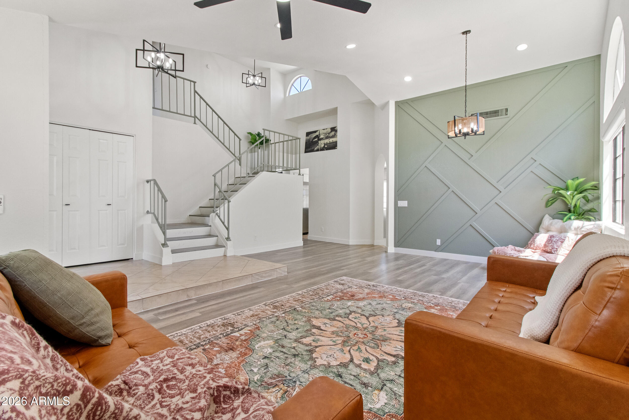 Light, bright, and full of charm, this 4 bed, 2.5 bath home offers over 2,100 square feet of inviting living space in Chandler's Strawberry Point community. Soaring vaulted ceilings and oversized windows fill the home with natural light, while fresh interior paint, updated lighting, and custom accent walls create a warm, modern feel. The kitchen features quartz countertops, stainless steel appliances, subway tile backsplash, and a stylish island overlooking the family room with fireplace. Outside, enjoy a private backyard with a sparkling pool, mature palms, and lush lawn. Desirable north/south exposure and a prime location near Gilbert's Islands community put you minutes from the US 60, Downtown Chandler, Downtown Gilbert, parks, shopping, and dining.