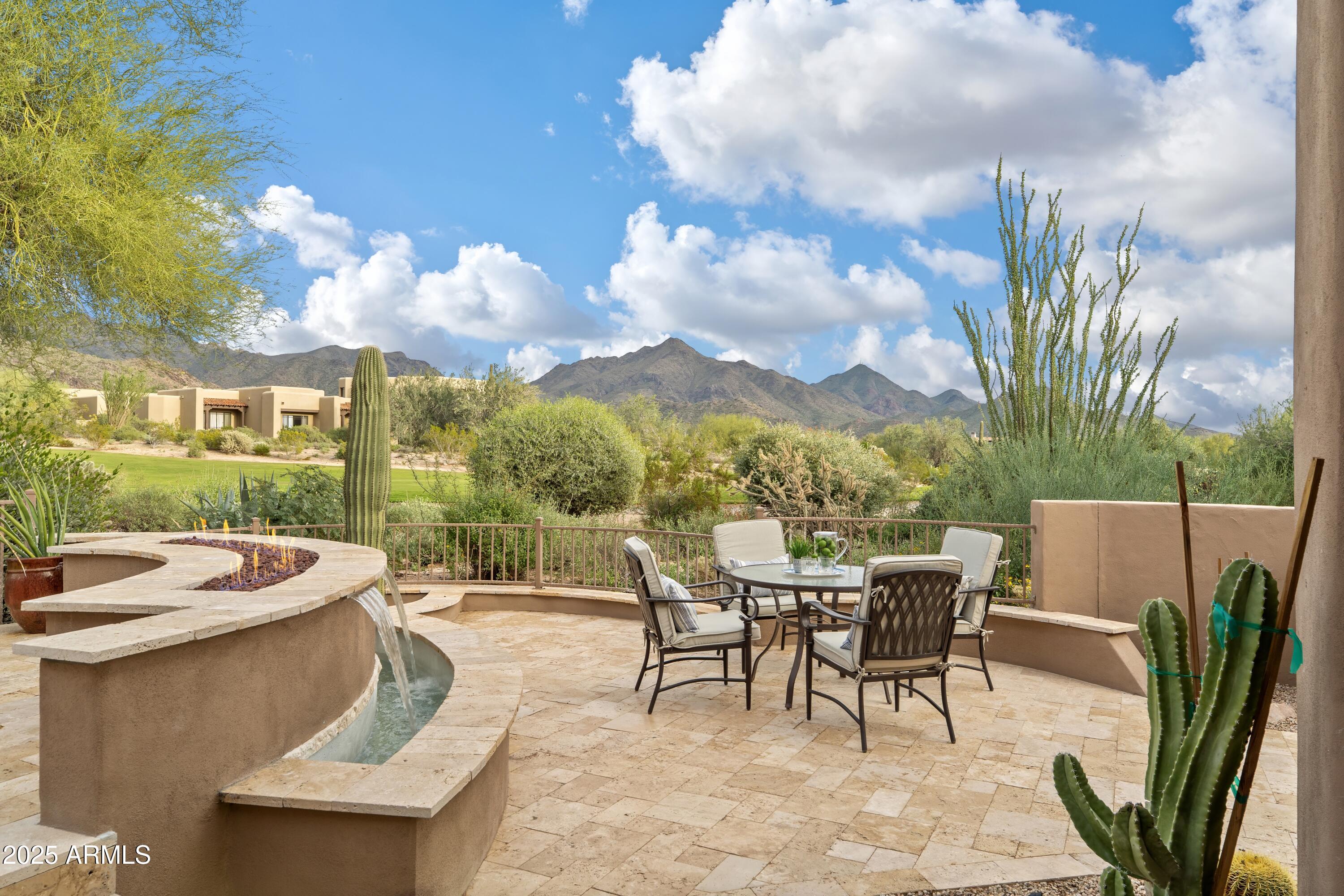Located within the prestigious guard-gated golf community of DC Ranch in North Scottsdale, this completely reimagined luxury townhome embodies the pinnacle of modern desert living. Perfectly positioned along the 18th fairway with unobstructed McDowell Mountain vistas, the residence offers a rare opportunity to experience elevated design, resort-caliber amenities, and effortless lock-and-leave sophistication in one of Scottsdale's most coveted enclaves.
 
Every element of the home has been thoughtfully transformed with premier, designer-selected finishes—from wide-plank white oak flooring and custom-crafted cabinetry to meticulously curated tilework throughout. The open-concept great room balances warmth and drama with exposed wood beams, a smooth-stucco fireplace, and expansive sliding glass doors that seamlessly frame the golf course backdrop as living art. The chef's kitchen serves as a refined centerpiece, showcasing Taj Mahal quartzite countertops, Calcutta Umber backsplash tile, and fully integrated panel-ready appliances that blend harmoniously with the space's soft, organic wood tones.
 
The main-level primary suite is a serene sanctuary, wrapped in Bedrosian's Sahara wall tile and enhanced by a freestanding soaking tub and spa-quality finishes that elevate everyday living. Upstairs, a versatile bonus room with a dry bar creates an intimate retreat for guests or private relaxation, while a second primary suite reveals sweeping city-light views. Thoughtfully designed for effortless luxury, the upper level also includes a seamlessly integrated stackable washer and dryer that enhances convenience for both family and guests without compromising aesthetics.
 
Outdoors, the residence continues to impress with a resort-inspired backyard crafted for elevated entertaining and relaxation. Ivory travertine pavers, two dramatic custom fire-and-water features, and a covered pergola dining area set the stage for memorable gatherings. Sculptural desert landscapingfeaturing agave, Senita cactus, and billowing pink muhly grassadds a curated, high-desert elegance to the setting.
 
With its designer finishes, breathtaking views, and enviable location within one of Scottsdale's premier golf communities, this turnkey residence defines modern desert luxury at the highest level. Just steps from the clubhouse, miles of scenic walking paths, and minutes from Market Street's upscale dining and boutique shopping, it offers an exclusive chance to experience DC Ranch living at its finest.

Round two of the open houses is underway and is guaranteed to be a success with construction now complete and the home fully staged. This newly listed property presents exceptionally well, showcasing phenomenal design, craftsmanship, and attention to detail throughout.