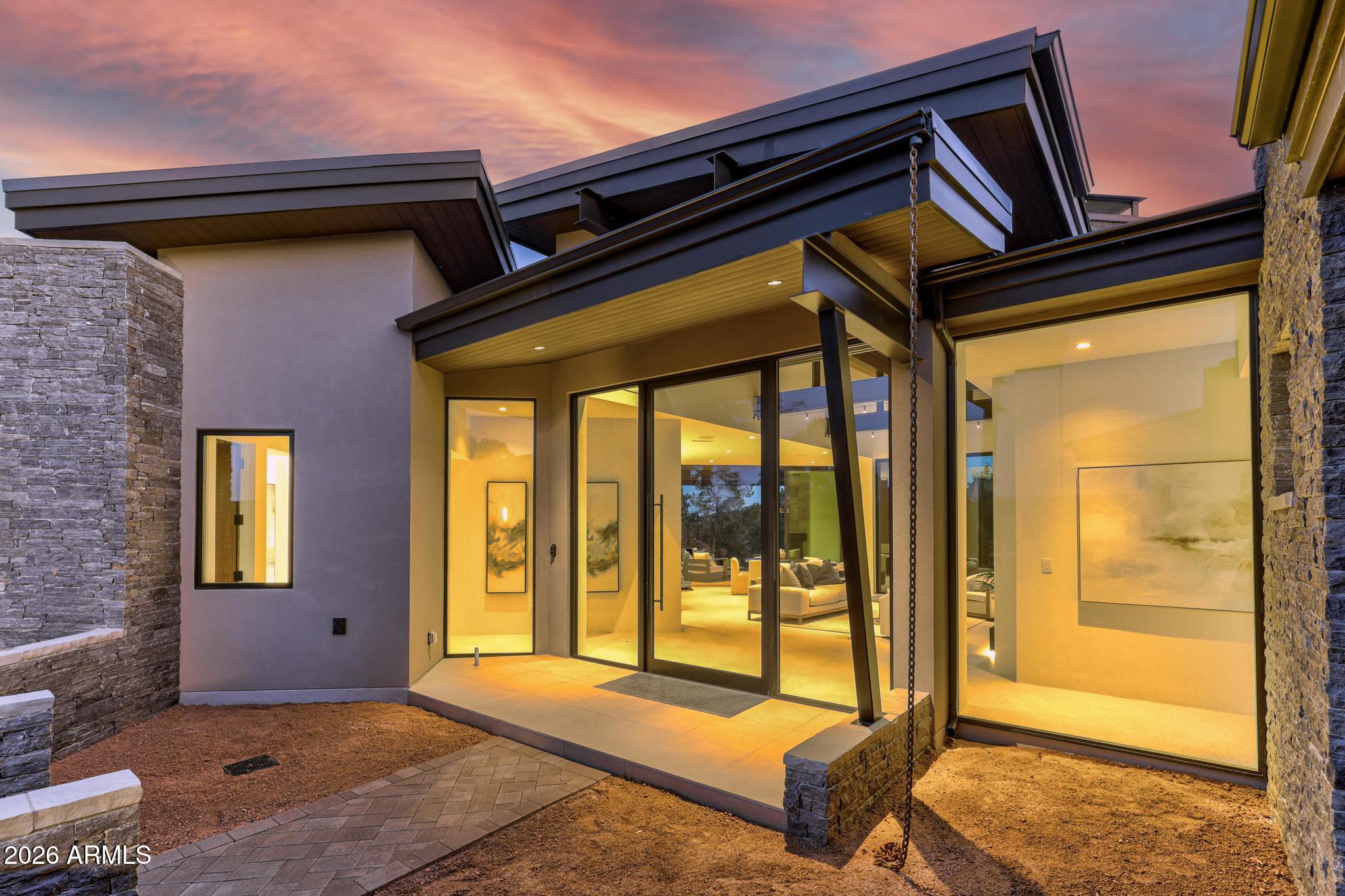 The Juniper Plan is part of Integra's Signature Series, architecturally pre-designed homes that eliminate the stress of starting from scratch while preserving the quality and customization today's luxury buyers expect. Juniper Plan - 3,178 SF - 4 Bed - 4 Bath |- Single Level. Experience refined mountain living in the Juniper Plan, a thoughtfully designed 3,178 sq ft single-level residence offering 4 bedrooms and 4 bathrooms with seamless indoor/outdoor flow. This modern mountain home features an open-concept great room with expansive glass, designer kitchen with oversized island, Wolf/Sub-Zero appliance package, and a spacious dining area ideal for entertaining. The private primary suite offers a spa-inspired bath and generous walk-in closet. Each secondary bedroom includes its own bath, p roviding comfort and privacy for guests. Enjoy covered outdoor living designed to capture fresh mountain air and natural surroundings. High-end finishes, quality craftsmanship, energy-efficient construction, and attention to detail throughout.
