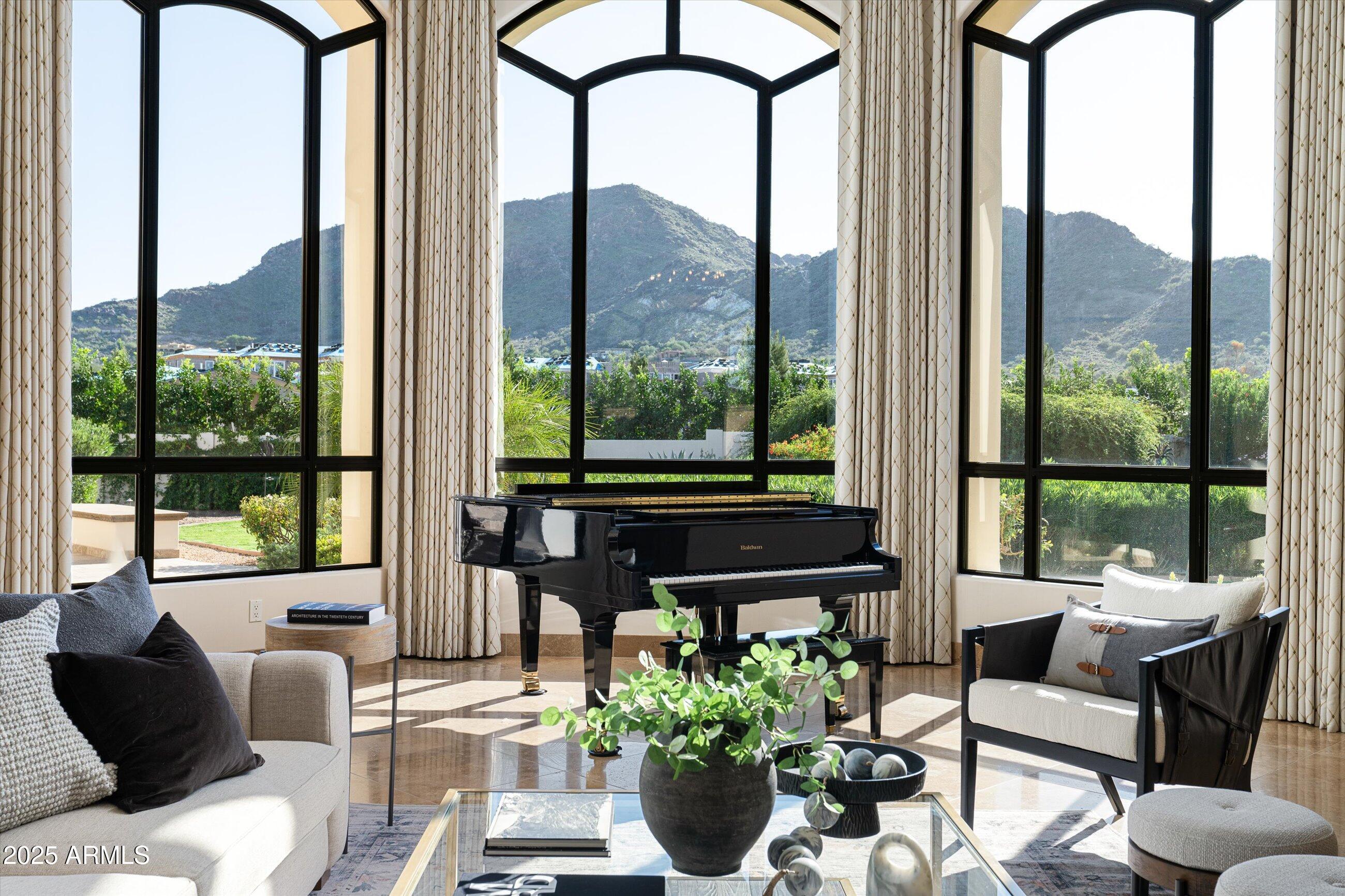 Located on one of the best streets in Paradise Valley and surrounded by $10M-$35M estates, this coveted Spanish Mediterranean residence combines timeless architectural character with a $1.5M renovation completed in 2017. The circular auto court leads to a privately gated 5-car garage and full detached guest house. The south-facing backyard showcases sweeping 180-degree views of Mummy Mountain and features a resort-style pool, spa, gazebo, gas BBQ, Bocce Ball court, & expansive covered patio. Chef's kitchen is outfitted with custom furniture-style Burdette cabinetry, a built-in Wolf coffee system, 4 ovens, 6-burner gas range, caterers prep area, wine fridge, & walk-in pantry. Private, peaceful, and a rare opportunity now at $903/SqFt all within the desirable Three C's school district.