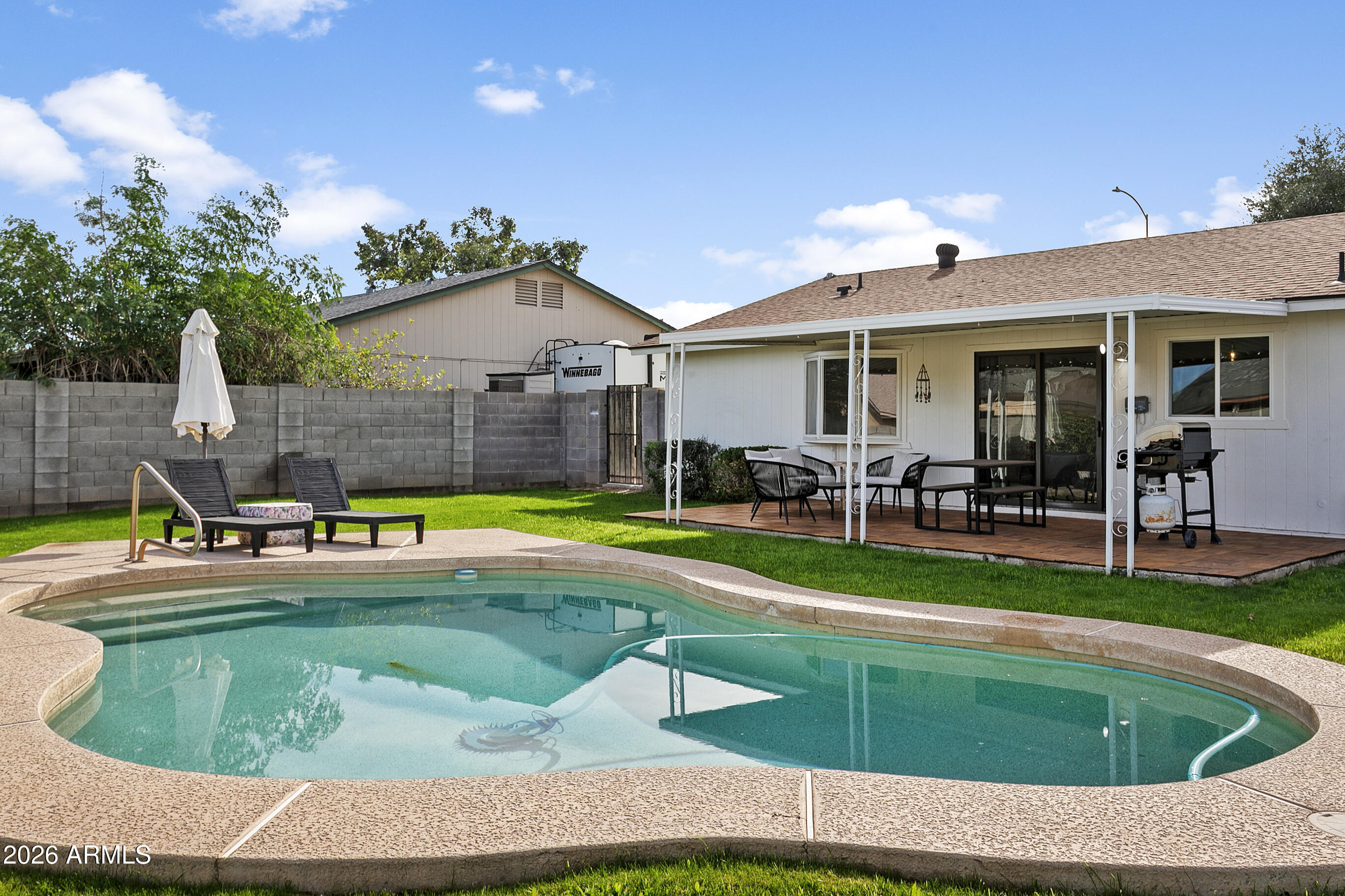 Welcome home to this beautifully updated pool home, where style and value meet. Recent updates include new flooring throughout, fresh interior and exterior paint, new water heater, updated lighting, new windows, and a remodeled bathroom. The open-concept kitchen features espresso cabinetry, granite countertops, a travertine backsplash, and stainless steel appliances. Step outside to a rare find at this price point--a spacious grass yard with a sparkling pool, perfect for relaxing or entertaining. Covered patio for morning coffee or evening unwind - PLUS a TWO CAR Garage and separate laundry room. Ideally located near 20+ restaurants, shopping, and everyday conveniences. Move-in ready and not to be missed!
