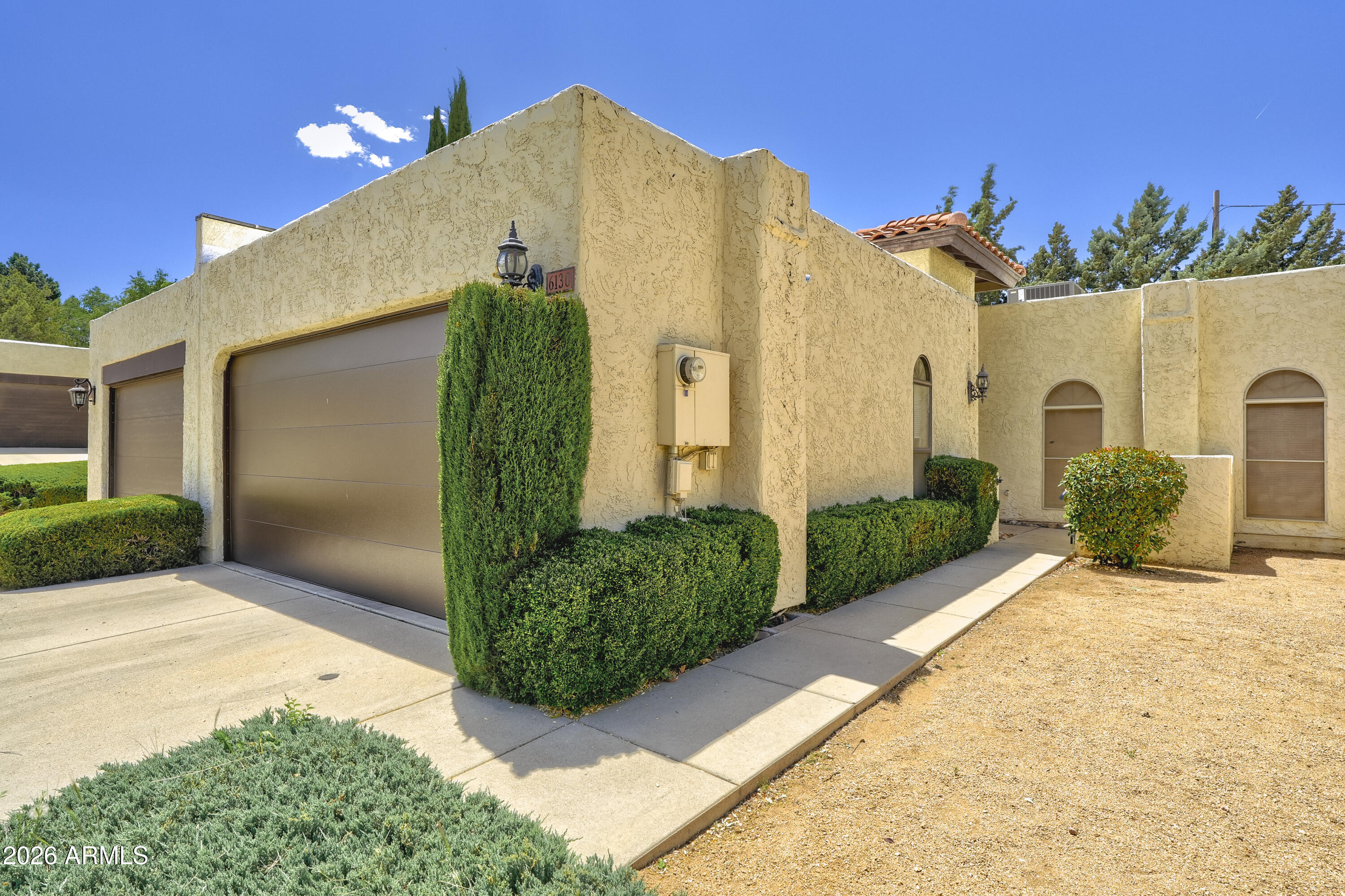 Great value in this Vista Montanesa townhome which is conveniently located to Antelope golf course, Emery Riddle and the airport. Enjoy the lock and leave life style where the low $200 per month HOA fees cover maintenance on the exterior of the buildings, landscaping in the front yards, common areas and maintenance of the streets. Walk to Manzanita Grill in the club house and enjoy one of the best breakfasts & lunches in town. 
This two bedroom two bath townhome boasts a large living room dining room which has high ceilings with beams, gas fireplace & glass sliders doors for access to the good sized back covered patio. The dining area has tons of built in cabinets for extra storage & a bar area. The primary suite also has glass slider doors to back covered patio & a large walk in closet. The primary suite also has glass slider doors to back covered patio & a large walk in closet. The guest bedroom also has a good sized walk in closet & door to guest hall bathroom. 
The kitchen has a Aquasana 2-stage water filter and a good sized laundry area. Wine refrigerator in kitchen will not convey.