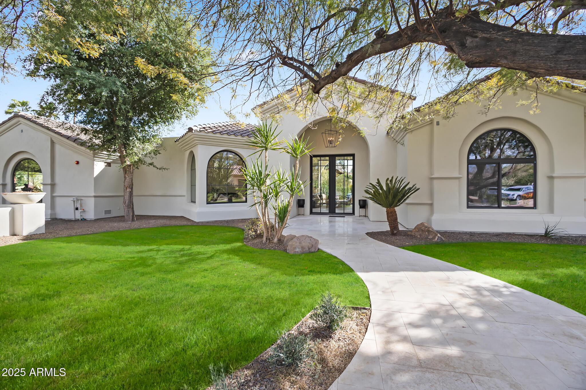 Nestled within the highly desirable guard-gated community of Cheney Estates in Paradise Valley, this newly renovated single-level home combines modern luxury with timeless elegance.

Boasting four ensuite bedrooms, four and a half bathrooms, and a dedicated office, the home is designed for both comfort and style. The grand living room features soaring ceilings, a striking fireplace, and elegant wood beams, creating a warm yet refined ambiance. At the heart of the home is the stunning chef's kitchen, equipped with marble countertops, top-tier Monogram appliances, and ample space for cooking and entertaining. Expansive windows allow natural light to flood the space and provide views of the pool and lush landscaping. Additionally, the spacious primary suite serves as a luxurious retreat with a spa-like bathroom, complete with a large soaking tub, beverage fridge, and a washer and dryer for added convenience.

Outside, the extended covered patio and sparkling pool create an ideal setting for relaxation or entertaining. This exceptional residence offers refined living in one of Paradise Valley's most sought-after communities.