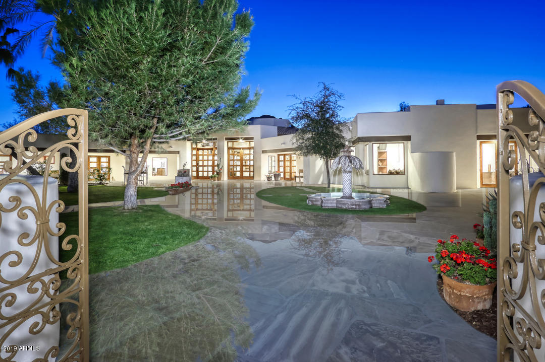 **Video & drone footage under photo tab and click video to watch.  Privately gated & tucked away on 2.4 acres in Paradise Valley w picture perfect views of Camelback & Mummy Mountains. Charming 8,000+ sf estate offers a true sense of  Southwestern Contemporary living. Main house features 2 master suites and 2 guest bed en-suite w baths, a gourmet kitchen open to family room & formal dining room & a large private office w sep entrance. Walk in wine cellar & numerous outdoor living areas make this home perfect for entertaining. Detached guest house w separate living area, kitchen, bed & bath. Resort backyard amenities incl a huge pool with slide & waterfall, spa, fire pit, pool room/bar and full bath, putting green, view deck and lush manicured backyard.  This home sold completely furnished.
