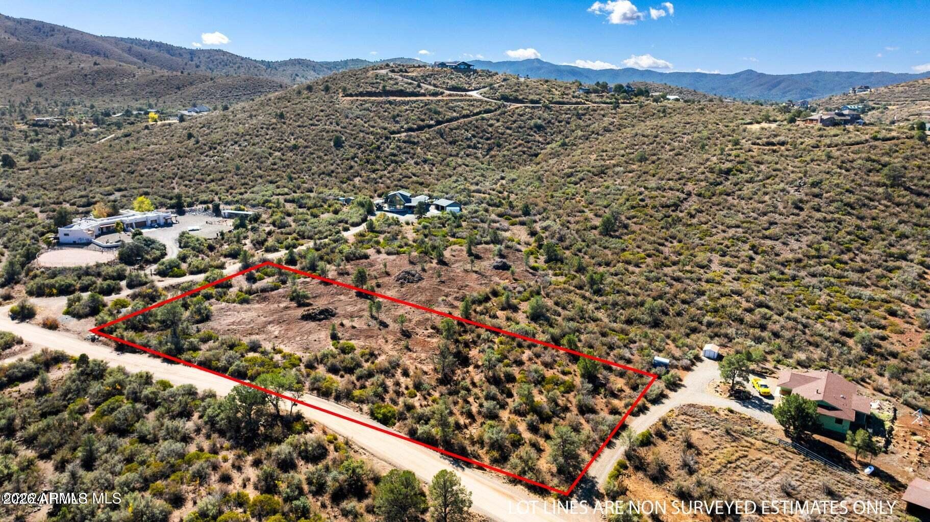Set on over 2 acres of gently rolling terrain, this exceptional homesite offers the perfect blend of usability and scenic beauty. The lot is predominantly flat with subtle elevation changes, maximizing both ease of building and panoramic views of the surrounding hills. A private well is already in place, adding immediate value and convenience for your future custom home. Ideally positioned for privacy yet easily accessible via a short, well-maintained gravel road, this property is ready to bring your vision to life.