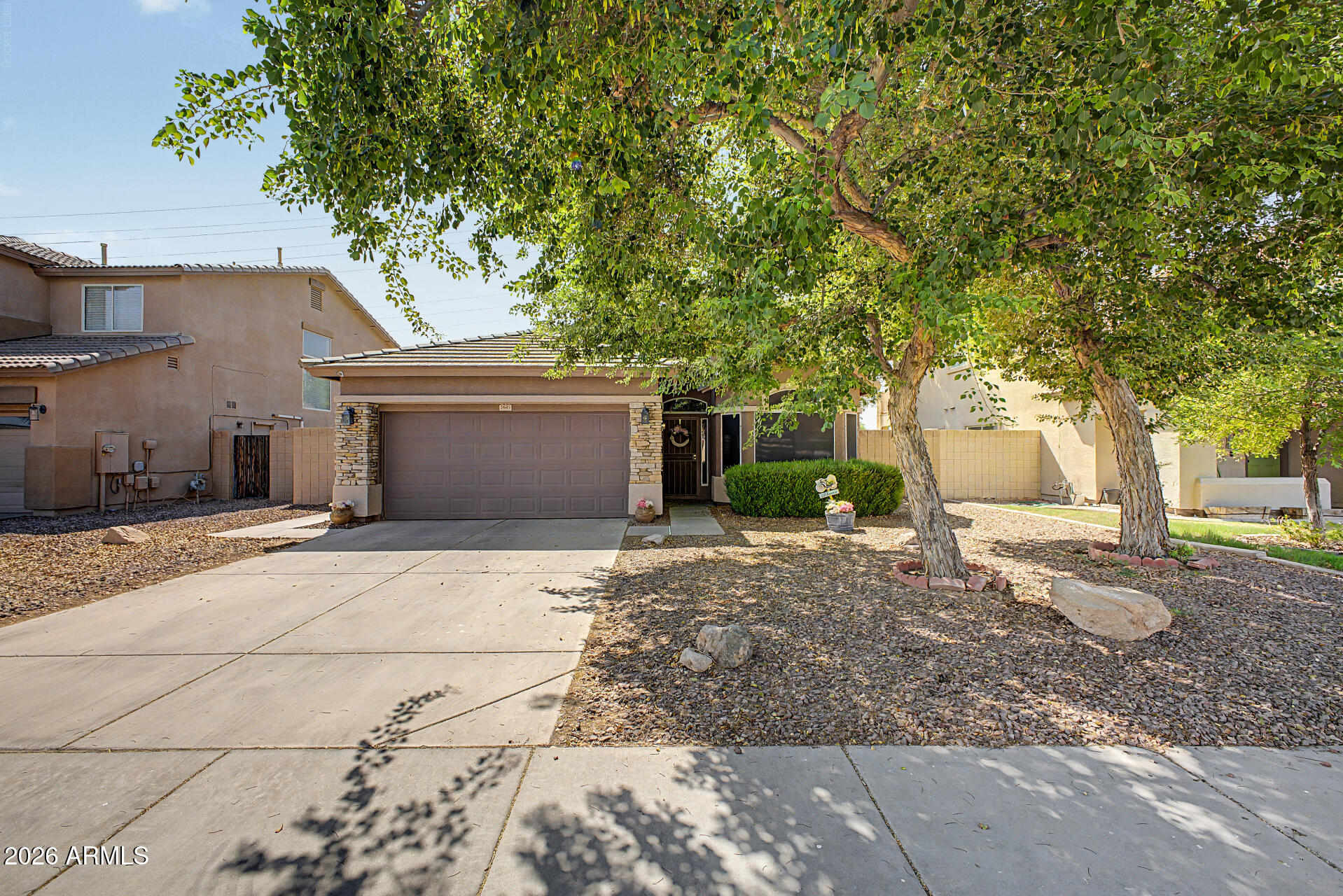 Experience the charm of this beautifully maintained 3-bedroom home in San Tan Ranch! Discover a mature front yard, a 2-car garage, and stylish stone accents adorning the front. Step into an open floor plan featuring a generous living area, tile flooring in high-traffic spaces, and a kitchen with abundant cabinetry, stainless steel appliances, a 2-tier island, and a dining nook with a bay window. The primary suite offers a private bath and walk-in closet, while all bedrooms feature plush carpeting and ceiling fans. The large backyard is perfect for unwinding under the covered patio or entertaining. Close to shopping, dining, San Tan Village, parks, and schools. This home delivers both comfort and convenience. Don't miss the chance to make it yours!