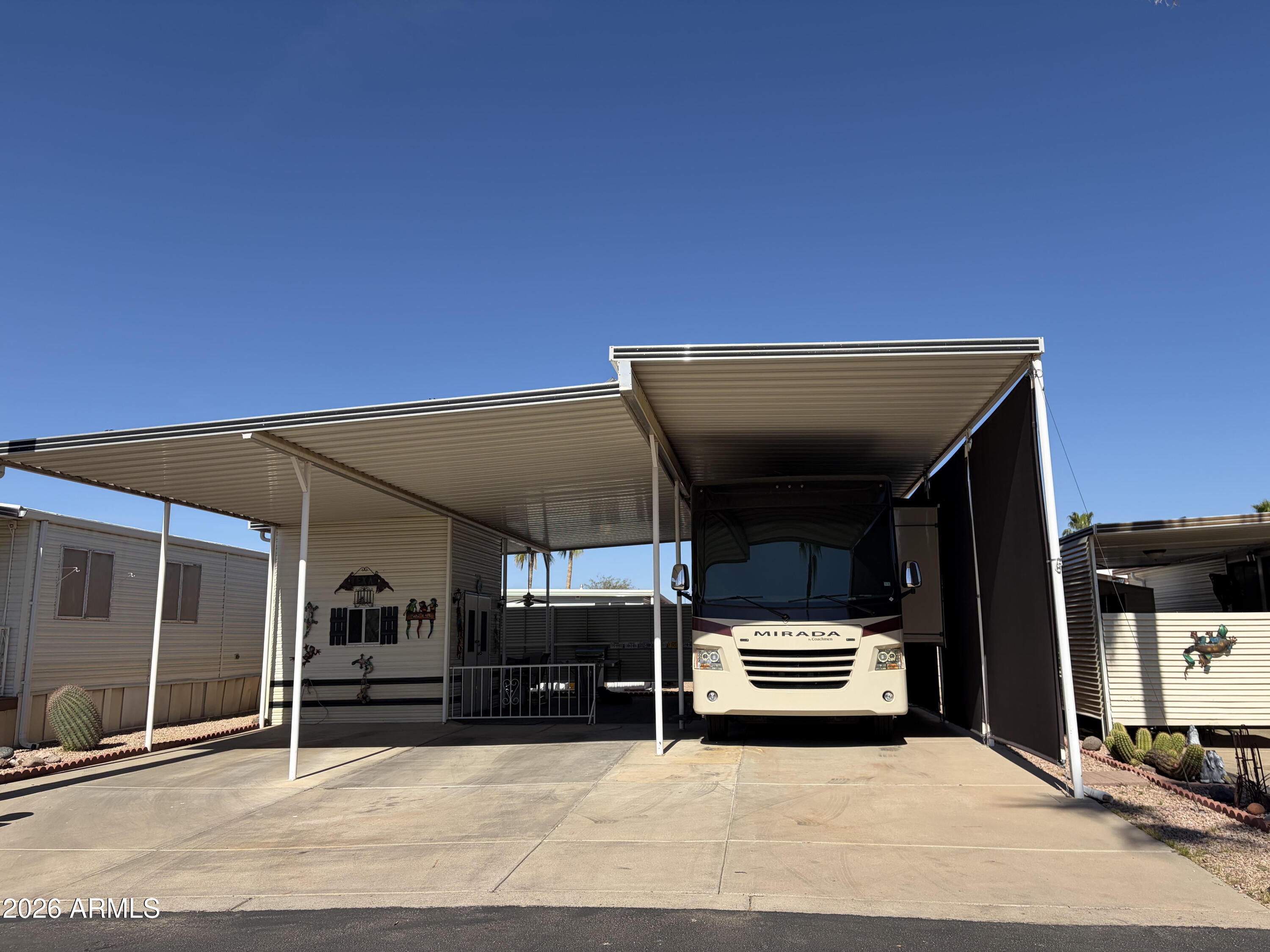 Fully Covered RV Lot in the Gated, 55+ Community of Happy Trails. Attached Casita/Shed features washer/dryer, sink and toilet and a  pull-down ladder that accesses the upper loft/storage area. Sprawling covered outdoor living space for entertaining or just relaxing and enjoying the lovely Arizona climate. Happy Trails Resort Community has loads of activities, including- Pickleball, Golf, Swimming Pools & Spas, Billiards, Fitness Center, Craft Clubs, a Restaurant and a large Dog Park. Low HOA fees cover water, sewer and garbage.