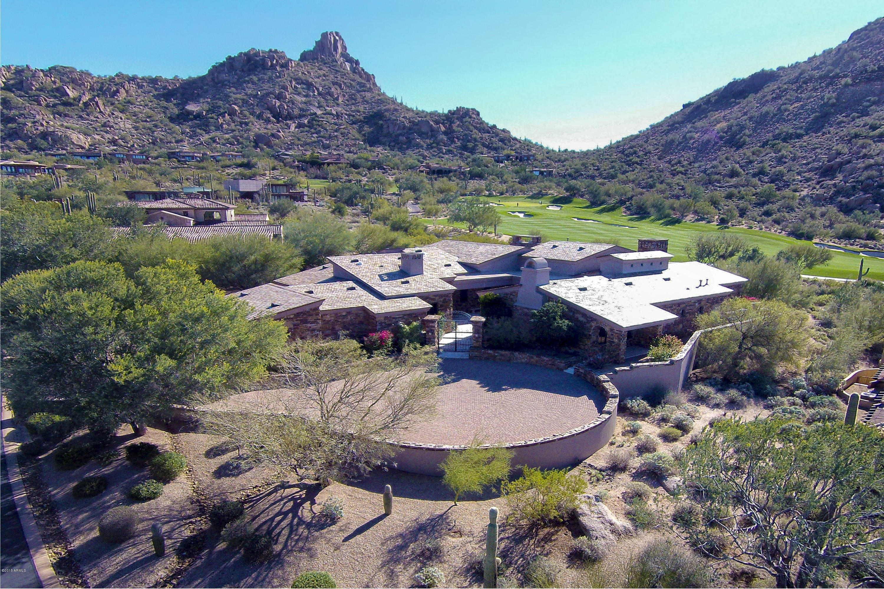 Elegant Tuscan inspired home by Bob Bacon with expansive Pinnacle Peak and golf course views in Estancia * Open, Great Room floor plan with soaring ceilings that frame massive Hope Steel windows to views * Large master suite with exercise studio and exceptional walk-in closet * Separate entrance guest house includes a living room with wet bar and bedroom with bath * Interior materials include Italian limestone flooring, Alder wood covered ceilings, Venetian plaster wall finishes and granite slab counter surfaces * Exterior materials are a rich blend of stacked stone, formed concrete, slate, wood and steel * Outdoor living includes a heated pool and spa, covered dining patio, gas fireplace and outdoor kitchen * The over-sized 3-car garage is climate controlled * Includes furnishings *