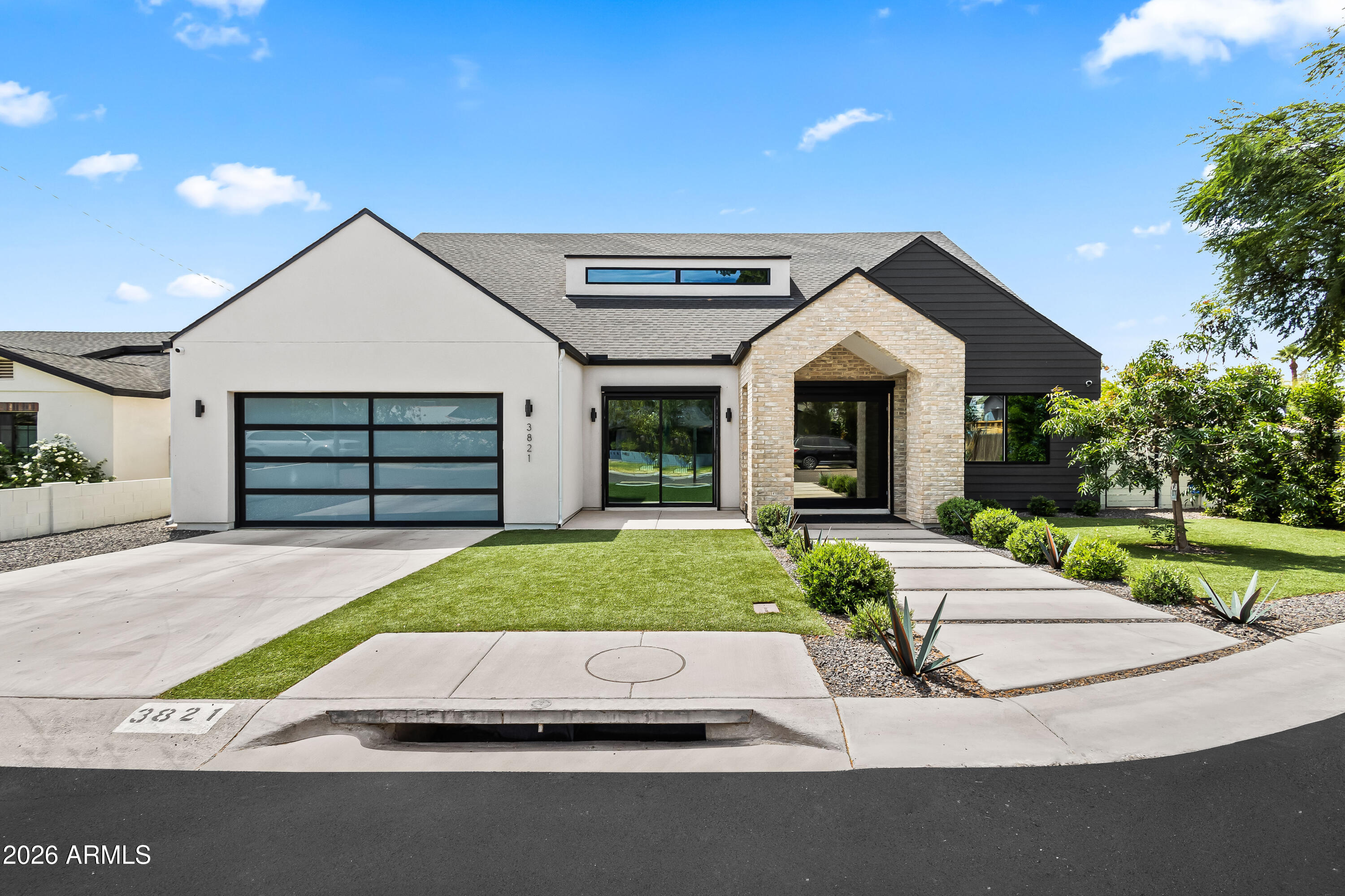 Modern luxury meets everyday comfort in this newly built two-story Arcadia home featuring 4 bedrooms, 5 bathrooms, plus an office, all thoughtfully designed for seamless indoor-outdoor living. Crafted for effortless entertaining, expansive windows and oversized sliding doors fill the home with natural light, highlighting white oak flooring, designer lighting, and elevated finishes throughout. The open-concept family room with fireplace flows seamlessly into the dining area and chef's kitchen, creating the perfect central gathering space. Designed with both style and function in mind, the kitchen features stainless steel appliances, dual islands, custom storage, and direct access to the backyard. The private primary suite offers a true retreat with a custom walk-in closet, dual vanities, freestanding soaking tub, oversized shower, enclosed toilet, and direct backyard access. A split floor plan provides ensuite guest bedrooms for added privacy and comfort, while the upstairs bonus room with balcony offers flexible space for a playroom, game room, gym, or additional lounge. Designed for year-round Arizona living, the backyard features a heated pool and spa, covered outdoor kitchen with BBQ, outdoor fireplace, full pool bath, and playground area. Ideally located in the heart of Arcadia, just minutes from Old Town Scottsdale and within walking or biking distance to local favorites including LGO and Postino, this exceptional home offers convenient access to premier dining, luxury shopping, golf, and resorts.
