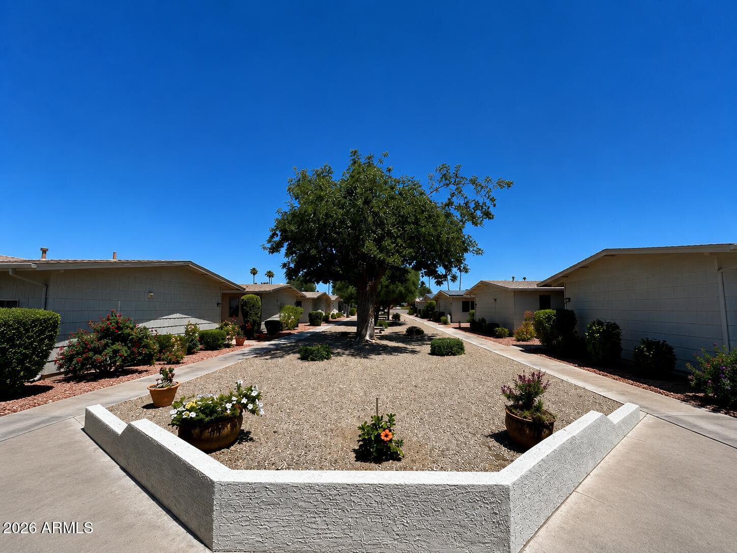 Beautifully updated and move-in ready! Enjoy low-maintenance HOA living in this charming 2-bedroom, 1-bath end-unit offering added privacy, modern upgrades, and exceptional indoor-outdoor living. Both bedrooms feature walk-in closets, while the bright enclosed Arizona room opens to the primary suite and dining area. The rare oversized private patio is perfect for relaxing, gardening, or entertaining. Features include tile flooring, plush bedroom carpet, fresh interior paint, built-in garage storage, a new garage door opener, and an A/C, kitchen appliances, washer, and dryer all less than 3 years old. Pet-friendly community with beautifully maintained grounds. HOA covers water, sewer, trash, roof maintenance and replacement, exterior painting, landscaping, and pest control.