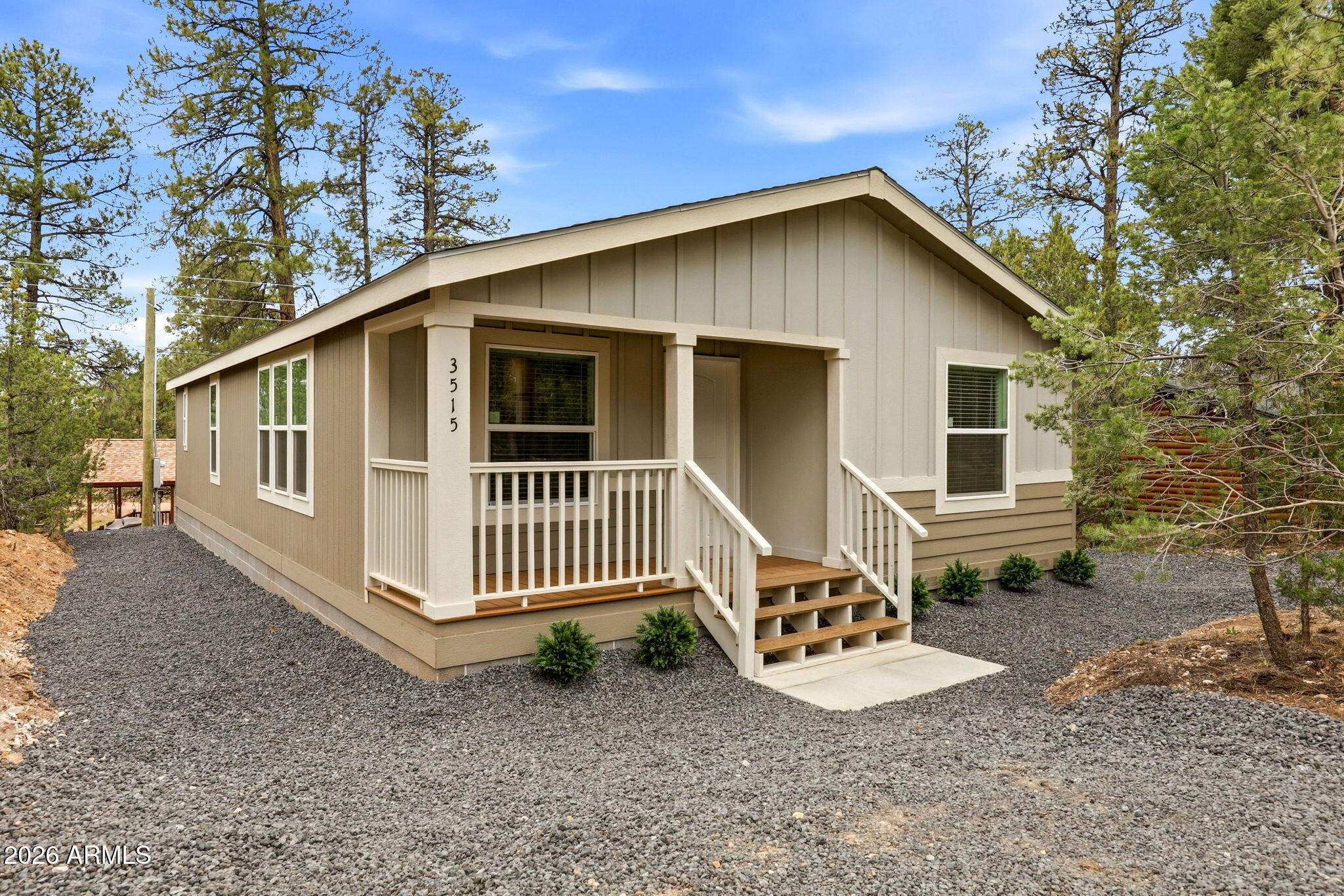BRAND NEW 2026 HOME. Enjoy cool mountain living, nestled among the pines. This thoughtfully designed home features two spacious master bedrooms. You'll find vaulted ceilings, open living spaces, plush carpet, and tile-look vinyl flooring, along with a modern kitchen with new stainless steel appliances. Relax on the charming front porch and enjoy the treed lot with a maintenance-free yard. Two driveways provide ample parking, with room for RV or trailer parking. Move-in ready and perfect for full-time living or a getaway!