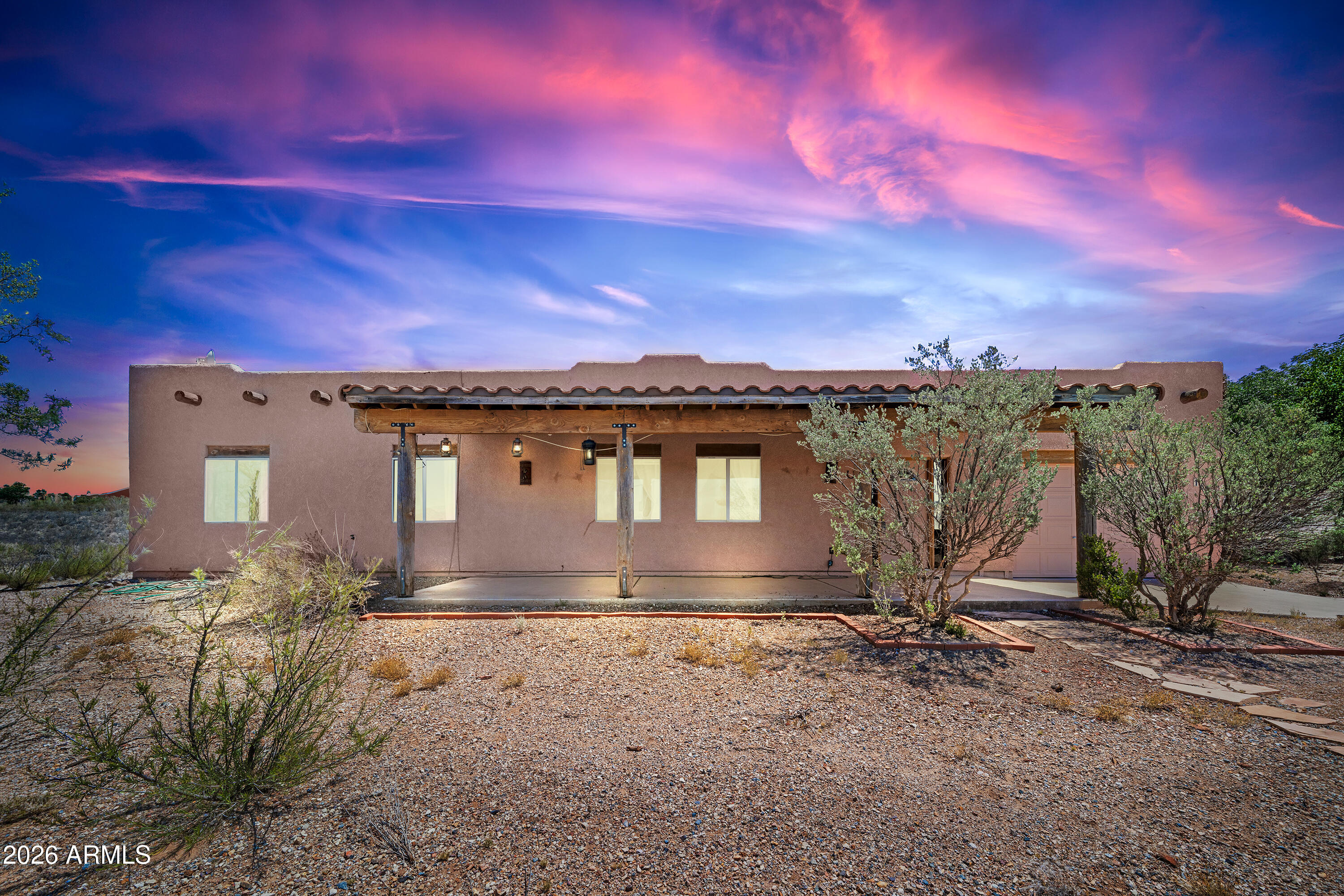 Experience authentic Southwest living in this beautifully crafted custom Santa Fe home, perfectly positioned on a .33-acre elevated lot with breathtaking mountain views and endless Arizona skies. Offering 3 bedrooms, 2 bathrooms, this thoughtfully designed home features an inviting open-concept floor plan centered around a spacious island kitchen complete with custom pine cabinetry, abundant counter space, and exceptional storage--ideal for the home chef and effortless entertaining.

Warm tile flooring, exposed viga wood beam accents, and timeless Santa Fe architecture create a welcoming atmosphere throughout. The generous primary suite provides a peaceful retreat, while the spacious guest bedrooms offer comfort and flexibility for family or visitors. Step outside to the expansive covered patio, where you'll enjoy spectacular sunrises, stunning mountain vistas, and the tranquility of Sierra Vista's high desert landscape. Whether hosting gatherings or simply relaxing with your morning coffee, this outdoor space is designed to take full advantage of the home's elevated setting.

If you've been searching for a home with character, quality craftsmanship, and unforgettable views, 1537 E Apache Way is ready to welcome you home. Own your own piece of the Wild West!