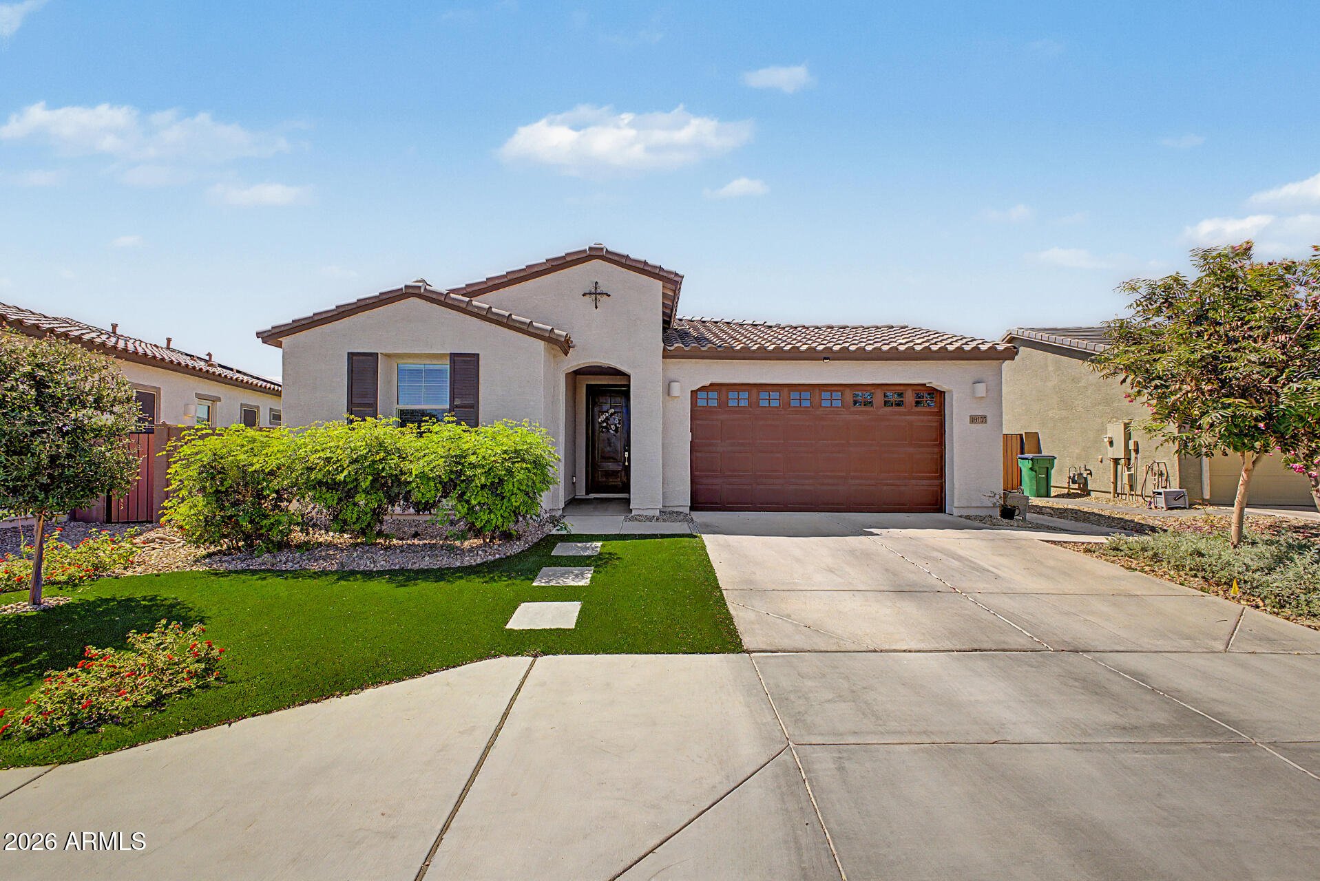 Live the Arizona dream in The Landings! Thoughtfully designed for the way you actually live, this stunning 4-bed, 3-bath split floorplan gives everyone their own space, including a luxurious primary suite w/ an oversized shower, dual sinks & oversized walk-in closet, plus a private guest ensuite. Cook and entertain in style w/ a chef's kitchen featuring a gas oven/range, quartz countertops, massive island w/ pendant lighting, pull-out shelves & an RO system. Tile in all the right places with hypoallergenic carpet in the bedrooms. Stay comfortable year-round with 3-zone climate control & energy-efficient shade screens. Outside your private oasis awaits! With an over-sized lot, real grass, a color-lit saltwater pool & extended covered patio, it's a place for golden-hour gatherings. The 2-car garage offers overhead storage and a tankless water heater. Close proximity to Loop 303, White Tank Mountains, grocery, and restaurants. This home is sure to please!