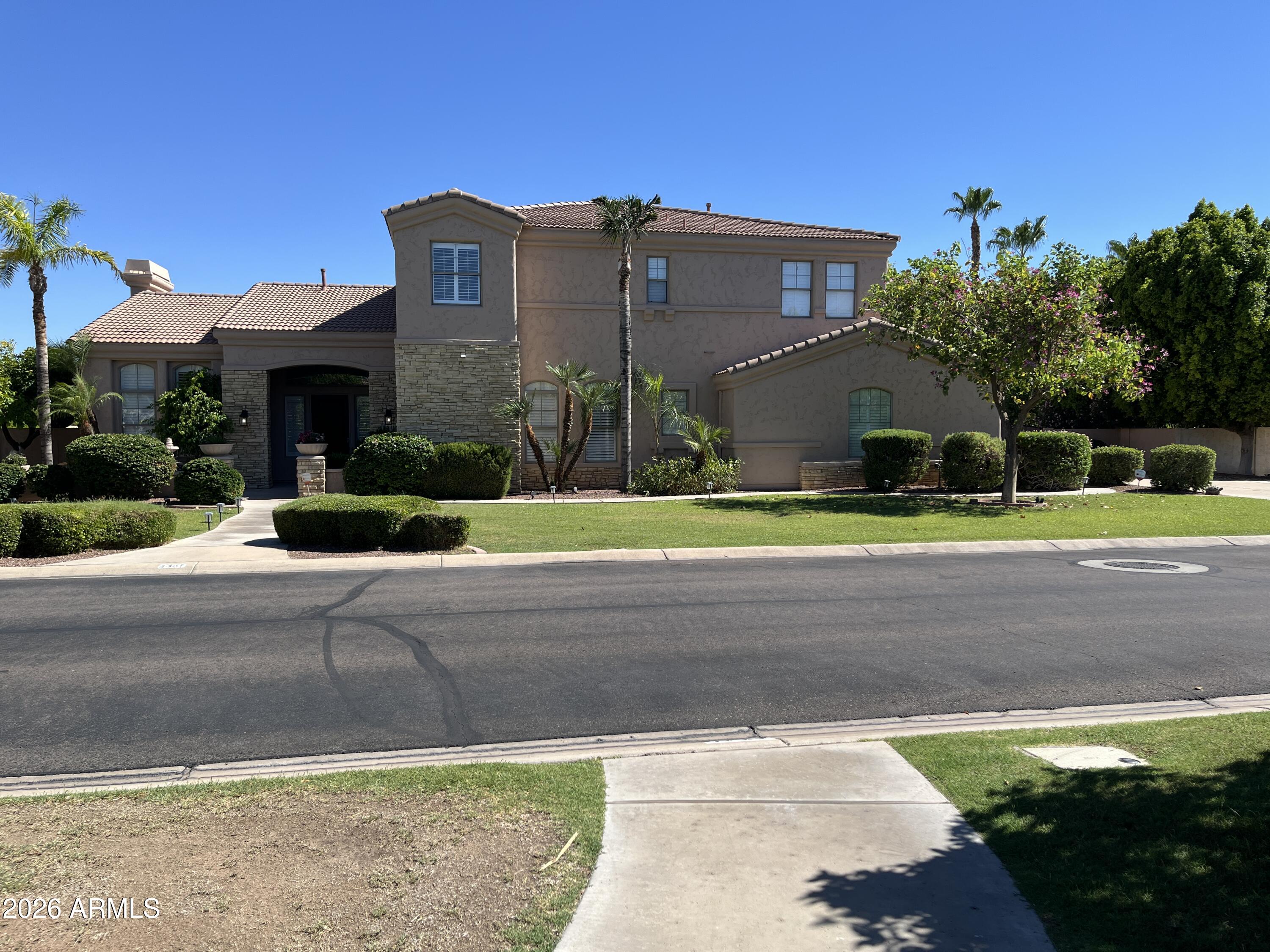 Discover the epitome of luxury living in the prestigious gated community of Arboleda. This exquisite 5 bedroom, 4.5 bathroom, two level, semi custom home is perfectly situated on a sprawling 6/10 acre lot right next to Arboleda Park, which contains sport courts, children's playground and ramada. Add to that a 1023 square foot separate casita with 2 additional bedrooms, 1 full bathroom, full kitchen, full laundry with wash sink, gas fire place, private outdoor porch, and a private garage with cabinets for storage. This residence caters to both comfort, sophistication and generational living possibilities. Come see all the recent upgrades. The gourmet kitchen is a chef's dream, featuring custom cabinets, built in side by side fridge/freezer, Asko dishwasher, Wolf double ovens, Wolf radiant cooktop, Wolf built in microwave, ice maker, quartz countertops, and sizeable eat in kitchen. Walk-in pantry. The oversized family room provides a welcoming space for relaxation and gatherings. Main floor also features a private en suite bedroom and a private office with built in book cases. 
Formal occasions are well accommodated in the combined formal living room with gas fire place and dining room, defined by 12 foot ceilings that enhance the home's spacious feel. Flooring throughout is a tasteful mix of new wood look plank tile and carpet, laying the foundation for your personal decor. Shiplap, wainscoting and crown molding add to the beauty of this home. The upstairs primary suite is a true retreat with sitting room space, two walk in closets and your own private balcony over looking the backyard. The primary bathroom features double counter sinks, a jetted tub, large shower with two side entrances and two private water closets for ultimate privacy. 3 additional bedrooms upstairs. One with its own bathroom and the other two are Jack and Jill with large bathroom in between, each having private sink/counter space. An additional bonus room offers flexibility for your lifestyle needs. Plantation shutters throughout. 3 car extended garage stays cool during Arizona summers with A/C split, built in cabinets for storage and epoxy flooring. And a 4th single car garage. Full exterior new paint. Dog run. Outdoor living is equally impressive. An outdoor oasis including a raised pergola, a diving board depth pool with child's play shelf, water features, spa and fire pit. Patio runs almost the length of the entire back of the house and provides shaded space for outdoor dining and leisure with a built in gas BBQ, burner, fridge and wash sink. Backyard includes multiple mature citrus trees (orange, lemon, grapefruit) all maintained with low-cost flood irrigation. Ample storage throughout the home adds to the convenience and appeal of this remarkable property. Located close to the 202 freeway, residents enjoy easy access to all parts of the Phoenix metro area, including PHX Sky Harbor. With top-rated schools and beautiful parks nearby, including the Mesa Tennis & Pickleball Center at Gene Autry Park, big league dreams, and Kensington Groves Park, this home is not just a residence but a lifestyle choice for those seeking the best in Mesa living.