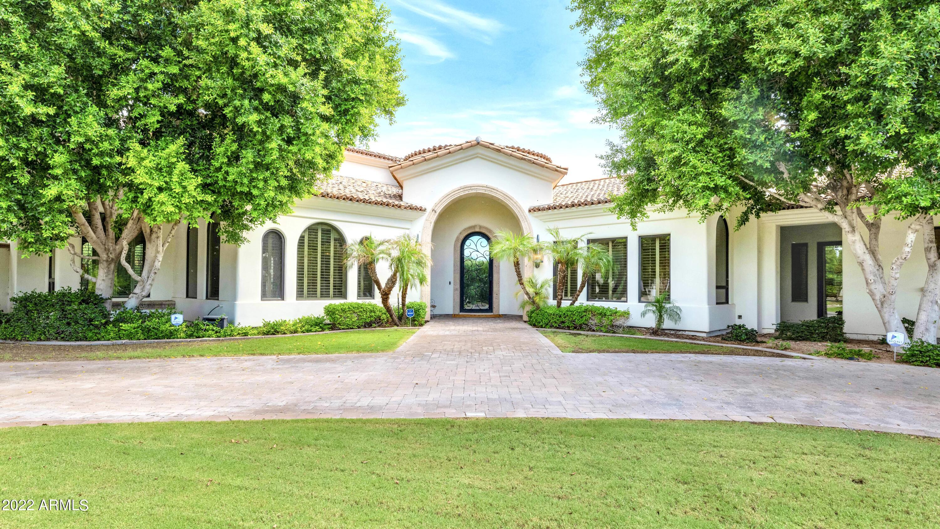 Exclusive and private, yet located in the heart of Arcadia, this beautifully updated sprawling Santa Barbara estate features a generous split floor plan with high ceilings and ample living spaces.  This home is an entertainer's dream with an oversized double island gourmet kitchen, separate bar, large sun-drenched great room, and separate formal living and dining areas.  A lush backyard with an outdoor kitchen and sparkling pool and spa wraps around the home and offers incredible views of Camelback Mountain.  The children's wing includes two en suite bedrooms and a large shared flex space.  The primary wing includes an oversized owner's suite with a sitting area, gas fireplace, and jacuzzi soaking tub.  The primary bedroom opens onto a dedicated office space. The detached casita with a separate entrance and large 3-car garage round out this spectacular property.