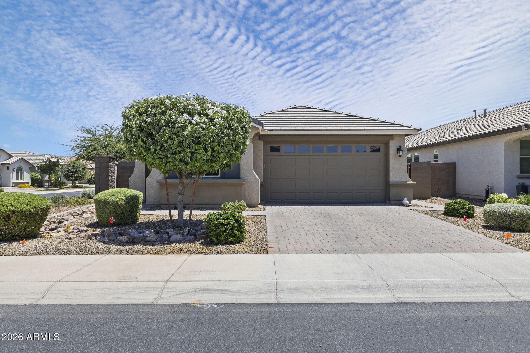 Welcome Home to this beautiful 3-bedroom, 2.5-bath home in the  Estrella Commons community. Situated on a corner lot with north/south exposure, This immaculate home offers outstanding curb appeal and feels like a model home from the moment you enter through the beautifully landscaped courtyard with decorative iron security door. Inside, you'll find a spacious den/office, large living area, and gourmet kitchen featuring granite countertops, gas stove, stainless steel appliances, and ample cabinetry. The bedrooms are generously sized and filled with natural light, creating a warm and inviting atmosphere throughout.  Step outside to a beautifully maintained backyard with fruit trees, colorful plants,
manicured landscaping, and space to relax or entertain.  A must see turn-key beautiful home.