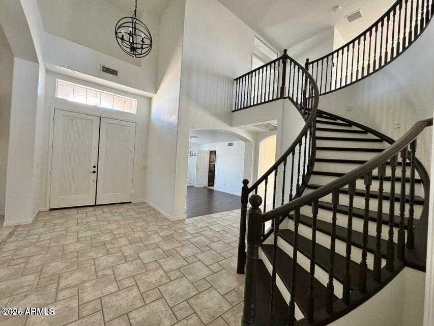 Experience luxury living in this meticulously updated Arrowhead Ranch estate. A grand circular staircase and soaring ceilings welcome you. The expansive layout features formal living & dining spaces, a cozy fireplace-lit family room, and a gourmet kitchen with an upgraded island. The main level offers a private guest suite, while upstairs boasts a versatile loft with a private balcony. Escape to the palatial primary retreat with a spa-like bath and massive walk-in closet. Outside, the resort-style backyard oasis shines with a sparkling pool, integrated spa, manicured lawns, and a custom gazebo. Includes a 3-car garage and all premium appliances. Unparalleled luxury living.