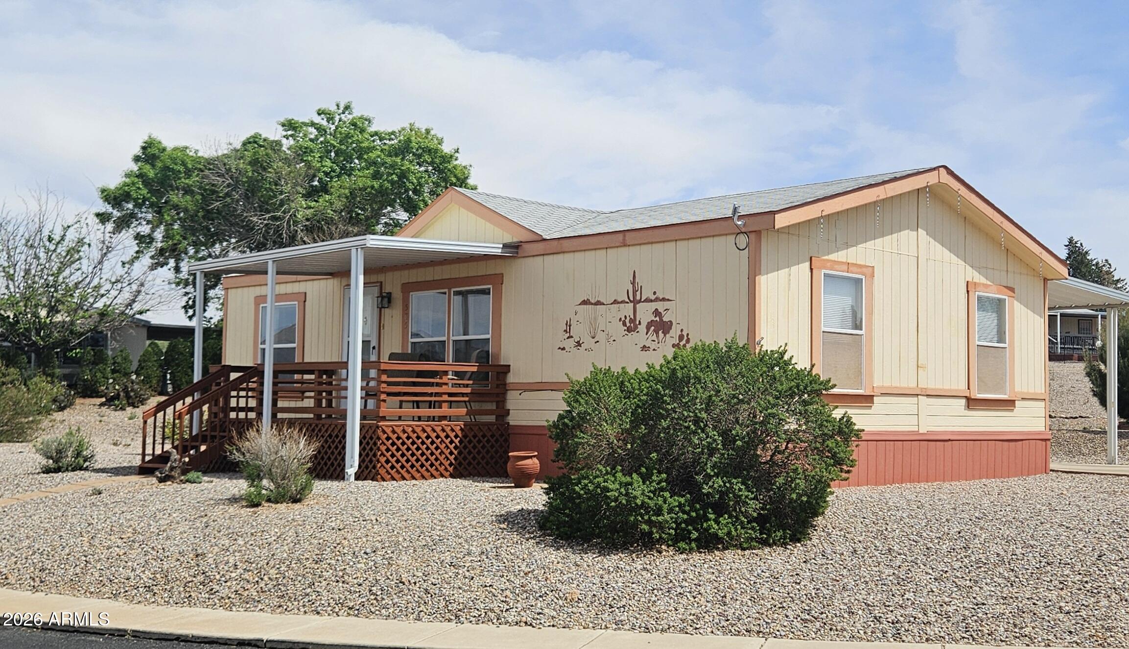 This is a very appealing home! 3 bedroom, 2 full bath. Split bedroom plan. Stainless steel refrigerator, gas stove and built in microwave. Washer and dryer included. On a large corner lot with easy care desert landscaping. Front and rear covered decks. One car carport. Located in the desirable gated community of Sierra Vista Village. Community offers an indoor pool and outside pool, spa, 2 clubhouses and many more amenities. Located close to shopping and center of town.