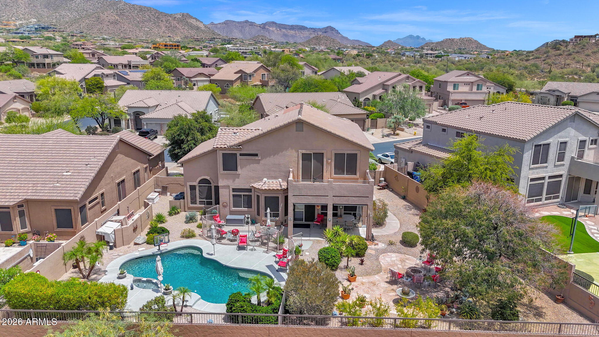 Move-in ready and beautifully prepared. This sought-after floor plan has been meticulously maintained and thoughtfully upgraded to impress even the most discerning buyer. Situated on an oversized yet private lot, this home offers room to relax, entertain, and grow. Enjoy summer days by the pool, gather beneath mature shade trees, or take in Arizona sunsets around the firepit. Inside, you'll find light, bright living spaces, neutral finishes, stylish selections, and brand-new carpet. A full bedroom and bathroom downstairs provide ideal space for guests, multigenerational living, or entertaining family and friends. Upstairs, the 5th bedroom is currently open to the primary suite, creating a perfect office, sitting room, nursery, or private retreat--with the option to enclose it with one wall for a true 5th bedroom. Located in a desirable golf community with A+ amenities, Grade-A schools, hiking and biking trails, pickleball, pools, parks, and year-round recreation. Just minutes from Scottsdale, Sky Harbor, and Falcon Field--this home delivers lifestyle, location, and comfort all in one.