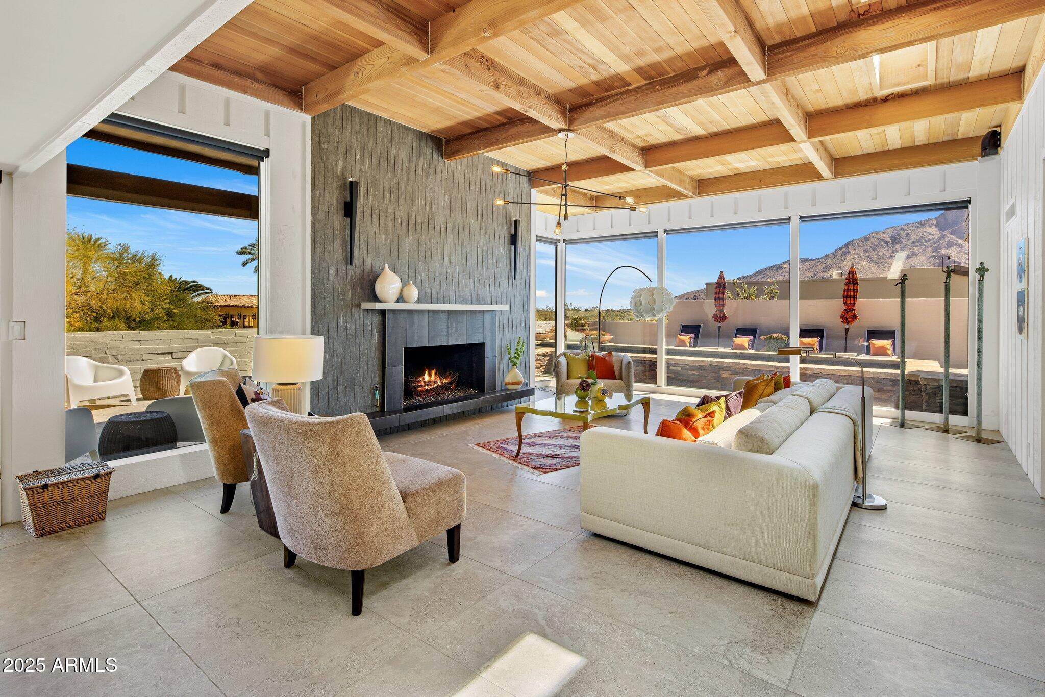 Experience ultimate seclusion in the highly coveted community of Guard Gated Colonia Miramonte. Nestled in a private location, this 4-bedroom, 4 bath home offers breathtaking views of both Camelback and Mummy Mountains. Enjoy seamless indoor-outdoor living with floor to ceiling glass walls that fill the home with natural light. This property features a pool/spa w/fire pots, two fireplaces, wood beam ceilings and massive outdoor patio space with center courtyard. City lights from upper deck. Embrace the beauty of this desert oasis right at your doorstep. Room service, car service and more available from the Camelback Inn.