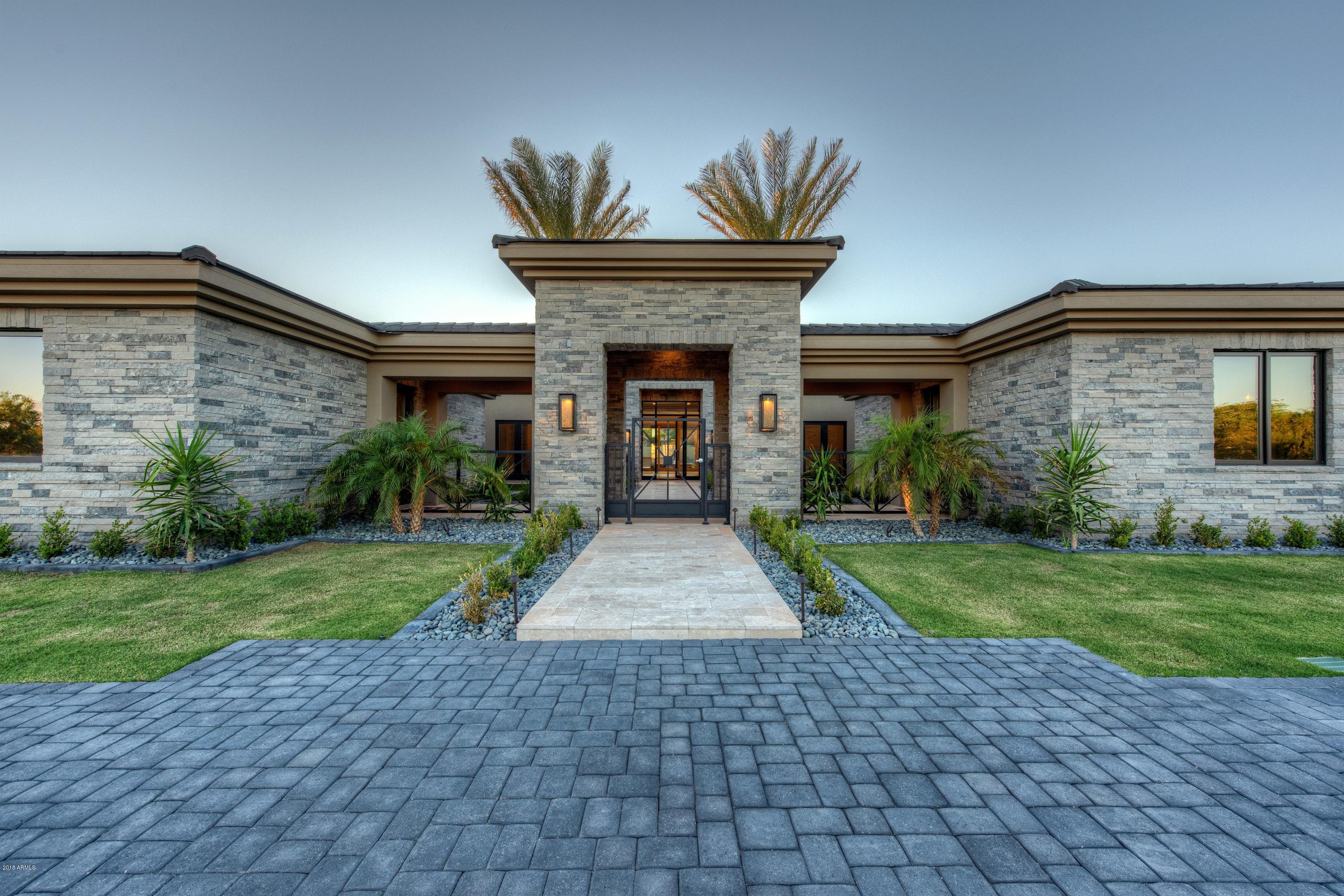 THE BEST VALUE IN PV...Just completed... The latest privately gated masterpiece by Legendary Homes. Situated on an A+ 1.13 acre lot with stunning Camelback Mountain views, this estate is jaw dropping. An open floor plan, his & hers offices, children's wing w/ three en-suite bedrooms & study area, a 15 person theater, exercise room, chef's kitchen, full bar & walk-in wine cellar. Not one but 2 guest houses, 1,400sf guest house & an additional guest casita. Clean, crisp and top-of-the-line finishes throughout the residence, boasting a feeling of natural beauty & casual elegance. Large format living spaces, expansive windows & hidden skylines allows the home to light up at all times. Private courtyards, pool/spa & cabana, this estate is set up for entertaining and relaxing.