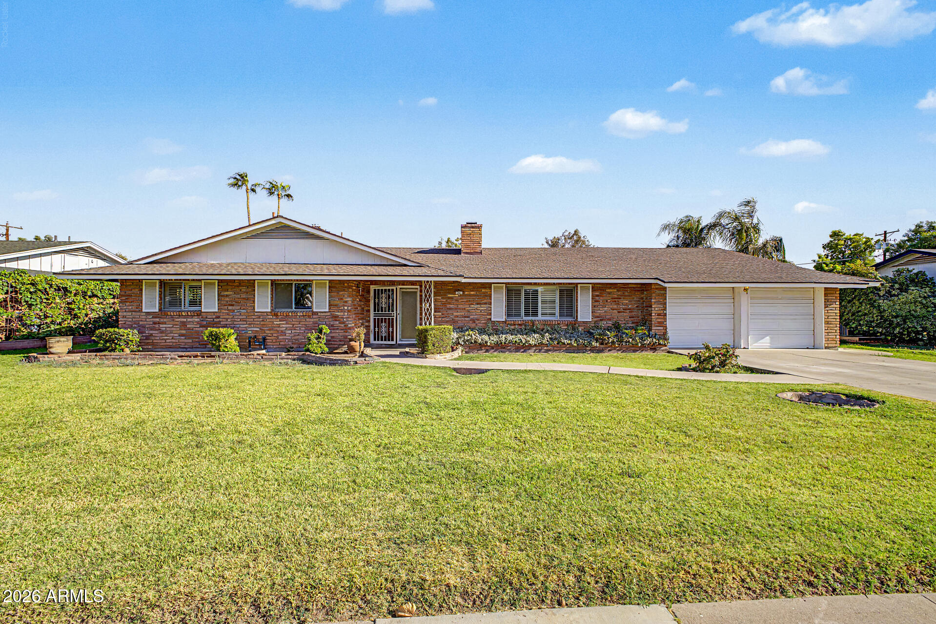 Situated on a generous 12,114 sq ft lot in an established, no-HOA neighborhood roughly 1 mile from Arizona State University, this spacious 5-bedroom, 3,260-square-foot home offers flexible living space with genuine character and recent updates. The expansive floor plan creates a natural flow between the home's main living areas, including a welcoming family room with a beautiful stone fireplace that serves as the heart of the home, an oversized great room, a spacious dining room, and a separate front living room. The primary bedroom and adjoining split bedroom have both been thoughtfully updated, along with new quartz kitchen countertops and a brand-new roof (2026). The remaining 3 bedrooms offer a blank canvas for new flooring and paint to match your style. A 110 sq ft walk-in pantry adds valuable storage, a rare find in a home of this era. Outside, enjoy mature landscaping, a covered patio, and a 2-car garage. Built in 1960 and full of potential, this home is just minutes from ASU, shopping, dining, and major freeways.